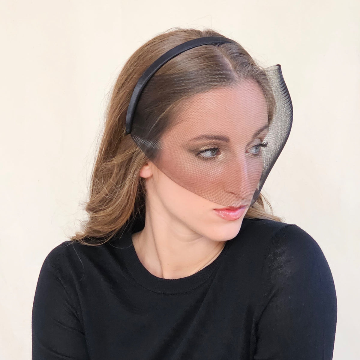 Close-up of black crin face-cage headband framing the eyes and
cheeks.