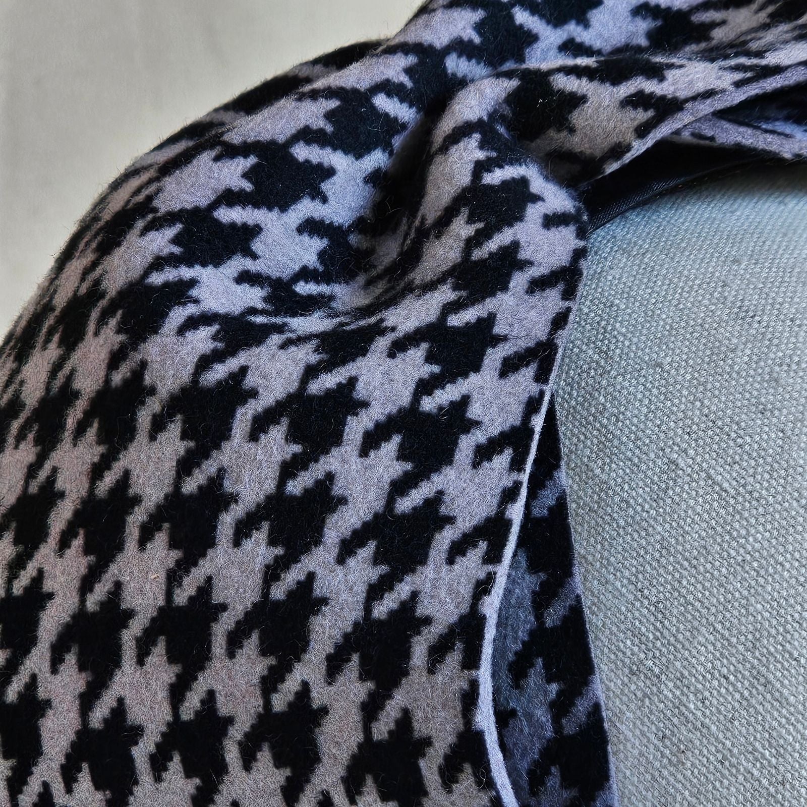 Detail of a headband with a black grey houndstooth felt bow.