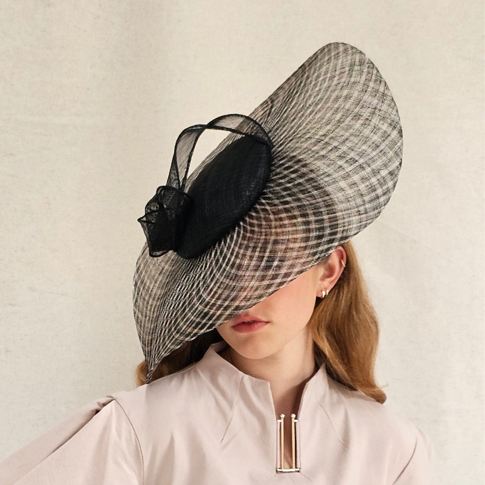 Black natural check disc hat with elegant sinamay knot, side view.