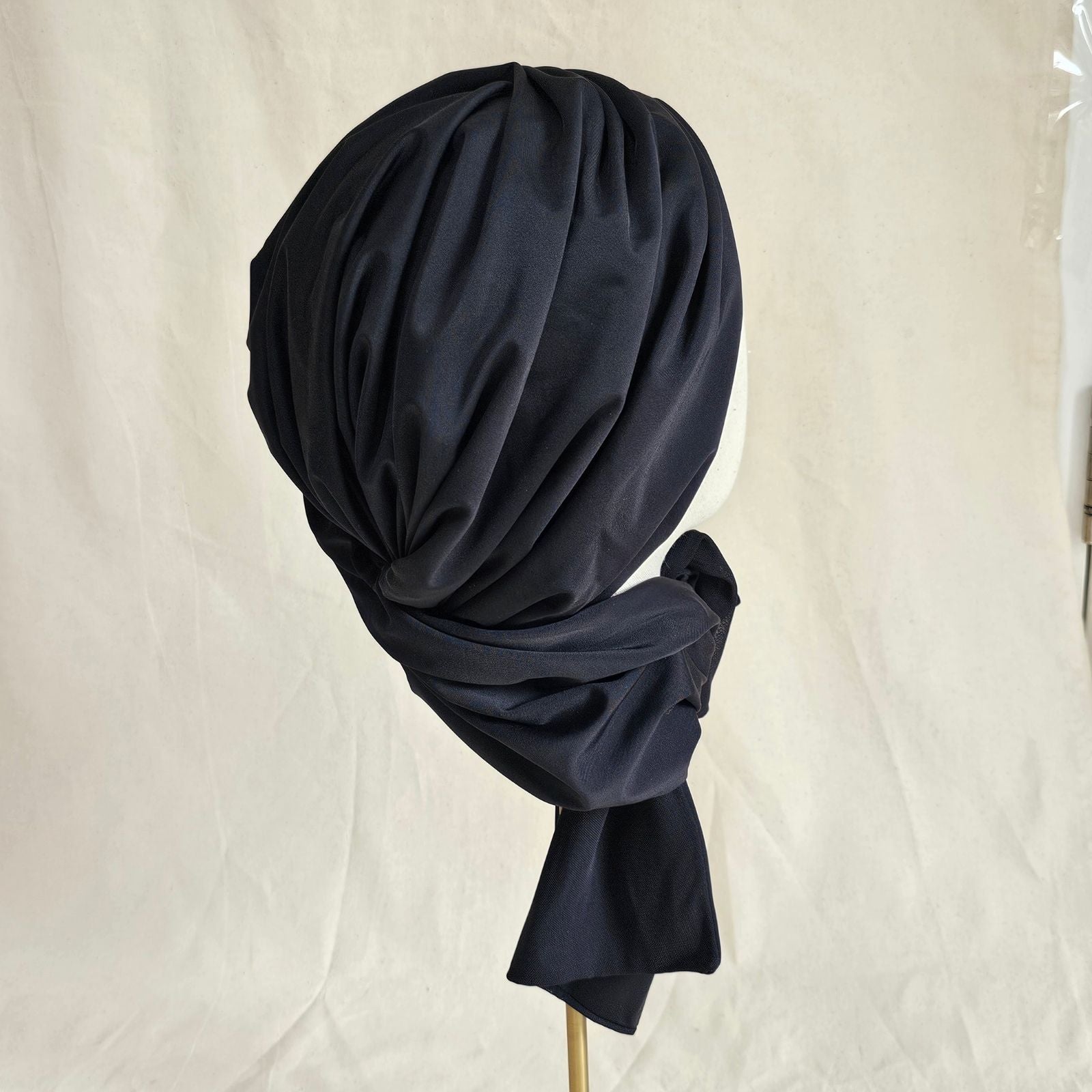 Black neck scarf swim turban with soft gathers, back view.