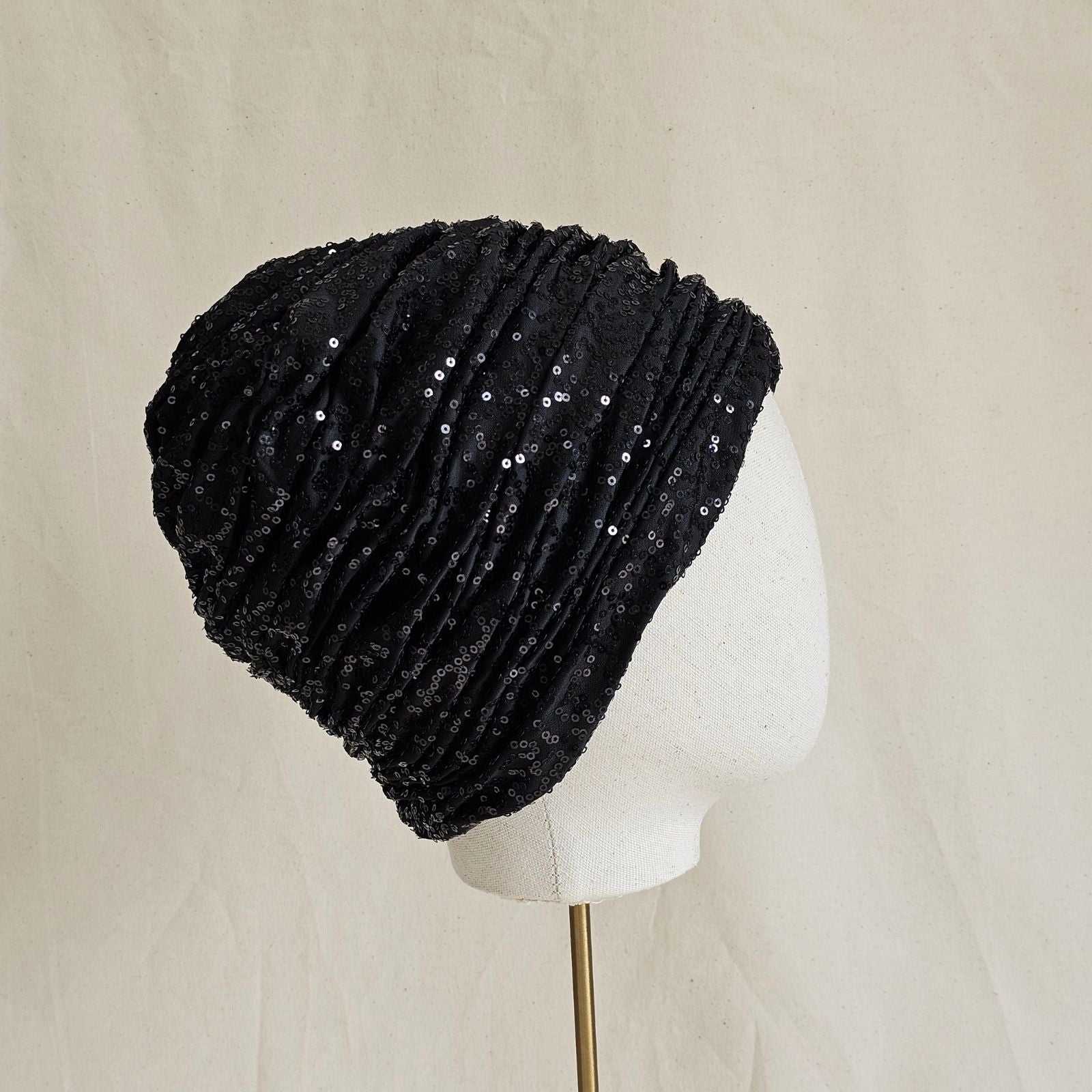Black sequin turban with beautiful gathers, side view.