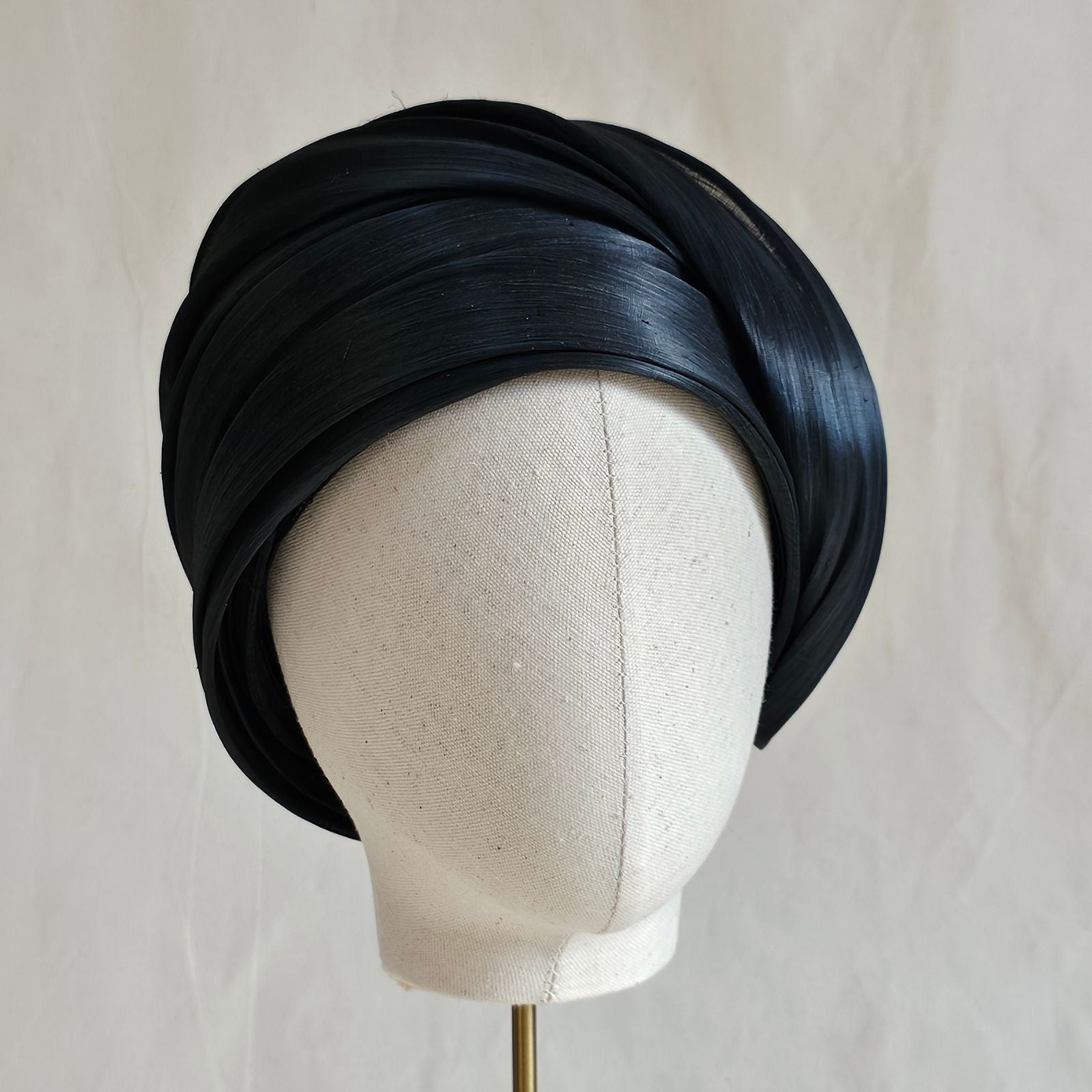 Black silk abaca turban hat with beautiful swirl, front view.