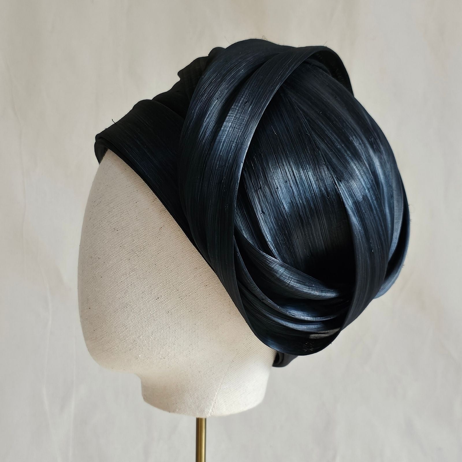 Black silk abaca turban hat with beautiful swirl, left view.