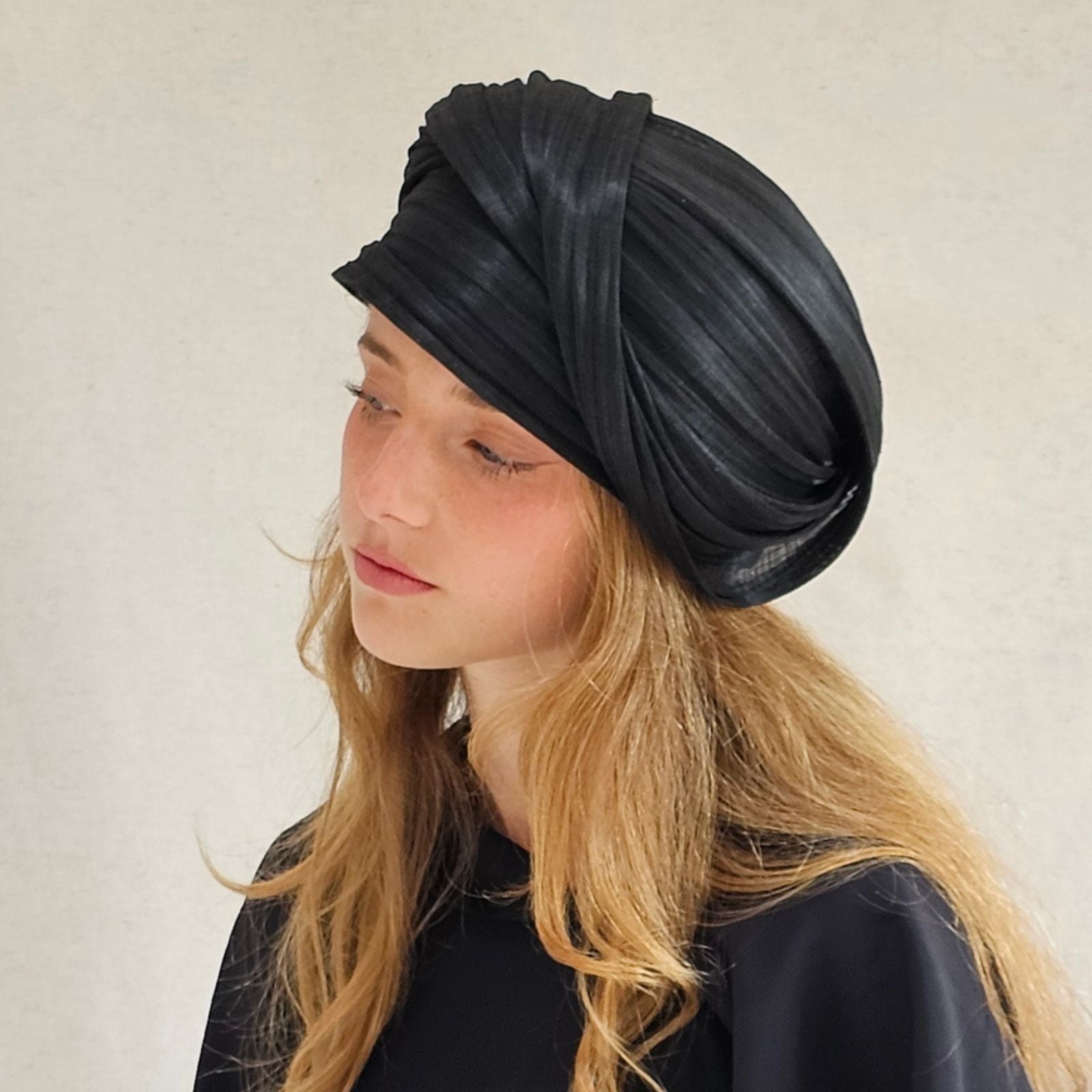 Black silk abaca turban with beautiful sheen, left view.