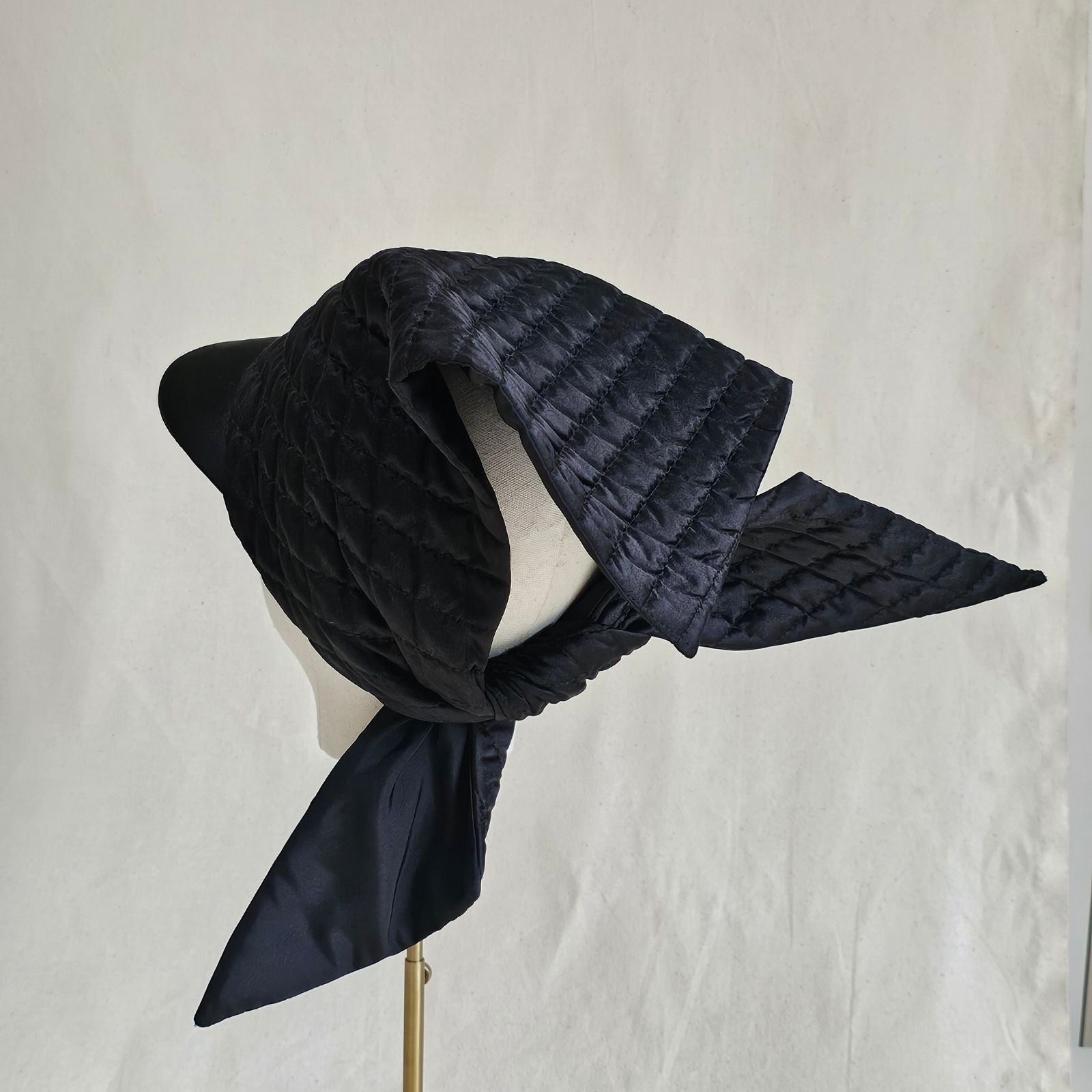 Black silk quilted peak scarf with dramatic back tie, back view.