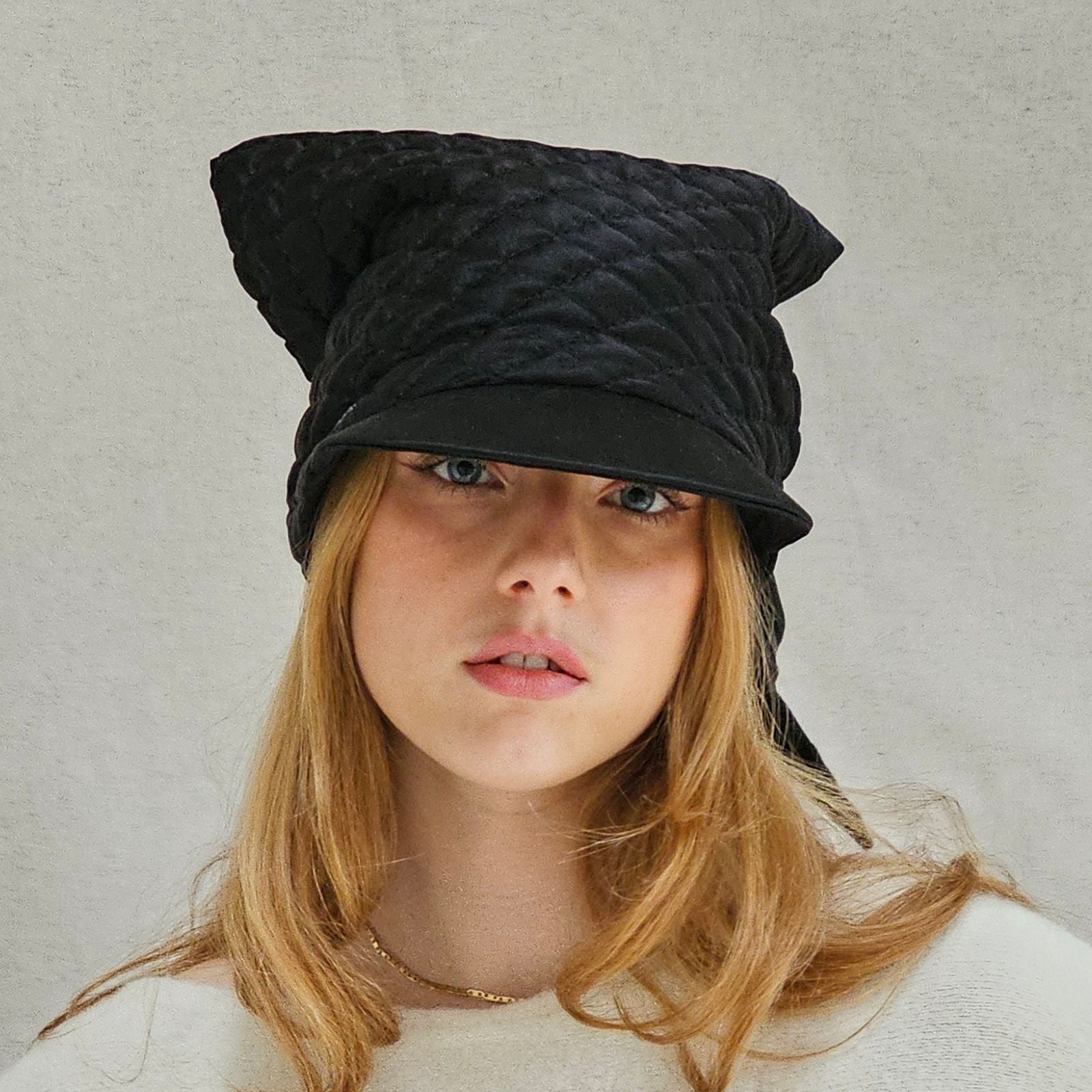 Black silk quilted peak scarf hat, front view.