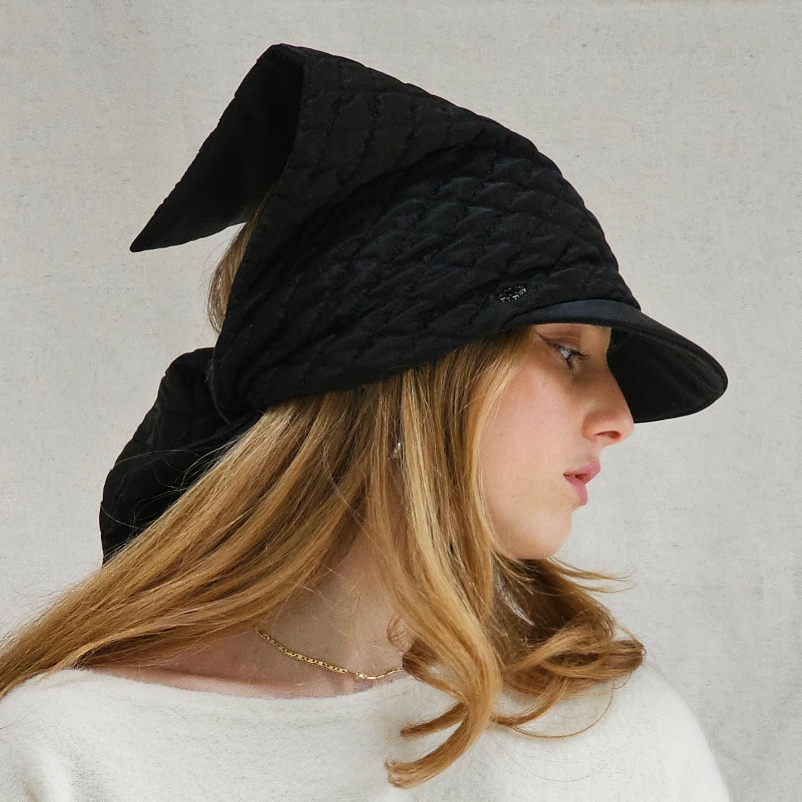 Black silk quilted peak scarf hat, side view.