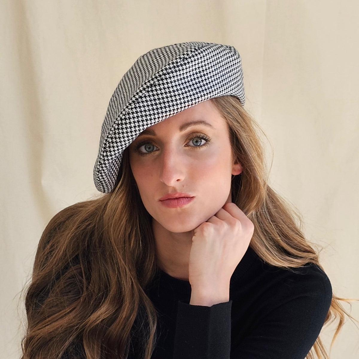Black and white wool houndstooth tam o'shanter, worn tilted on a
model.
