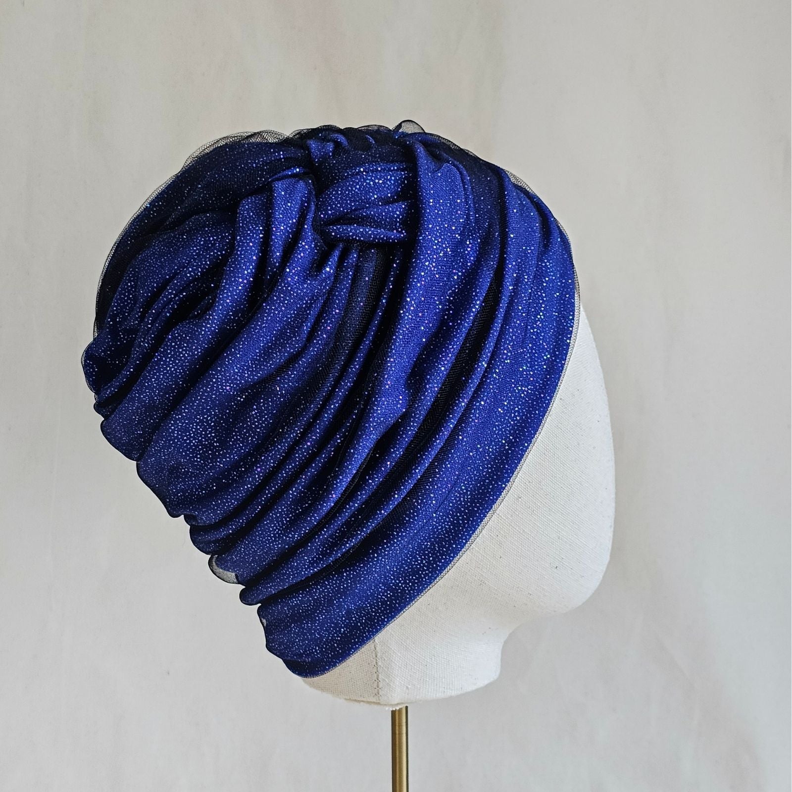 Blue sparkle turban with tulle, beautifully gathered and braided, right view.