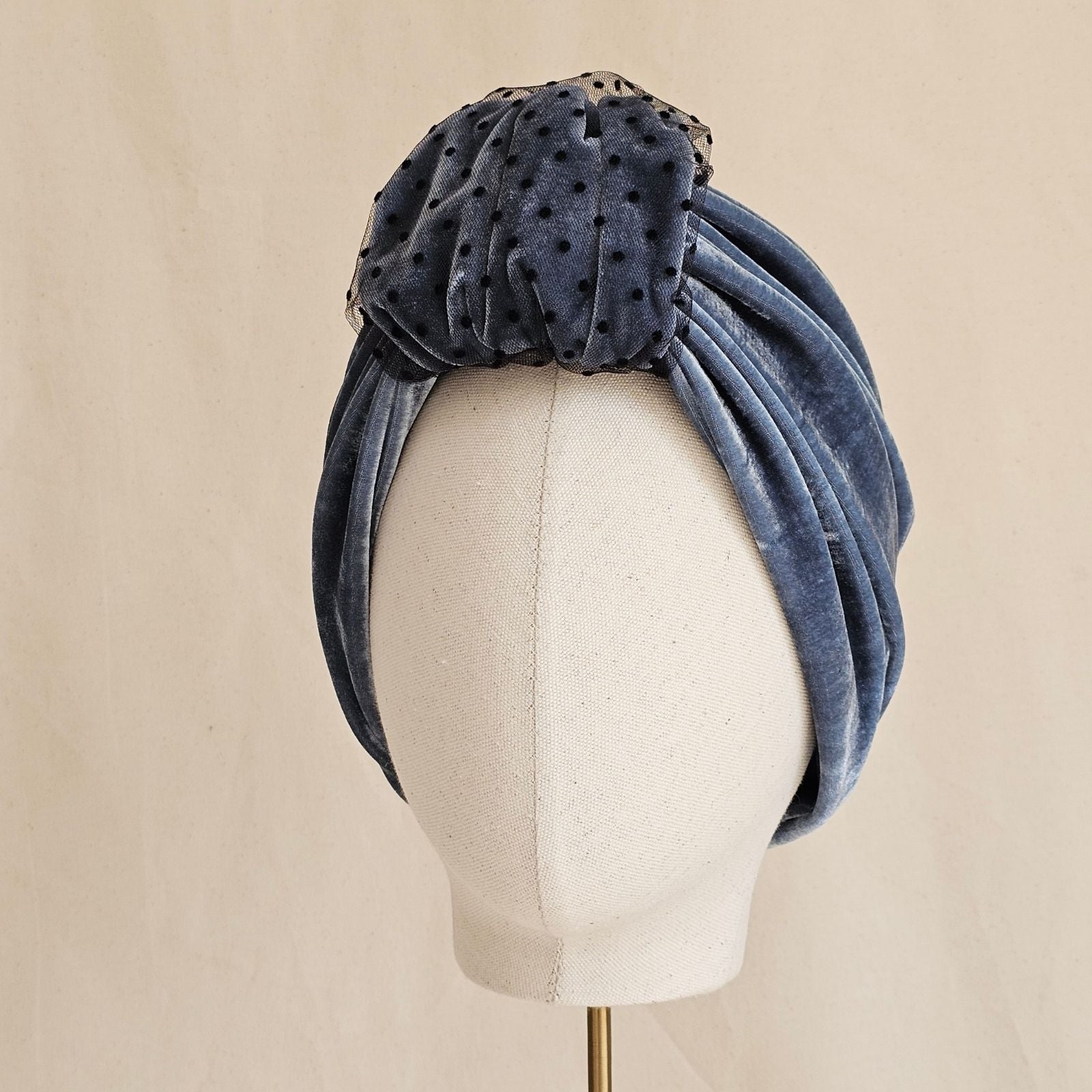 Blue velvet gathered turban with dot tulle detailed front loop, left view.