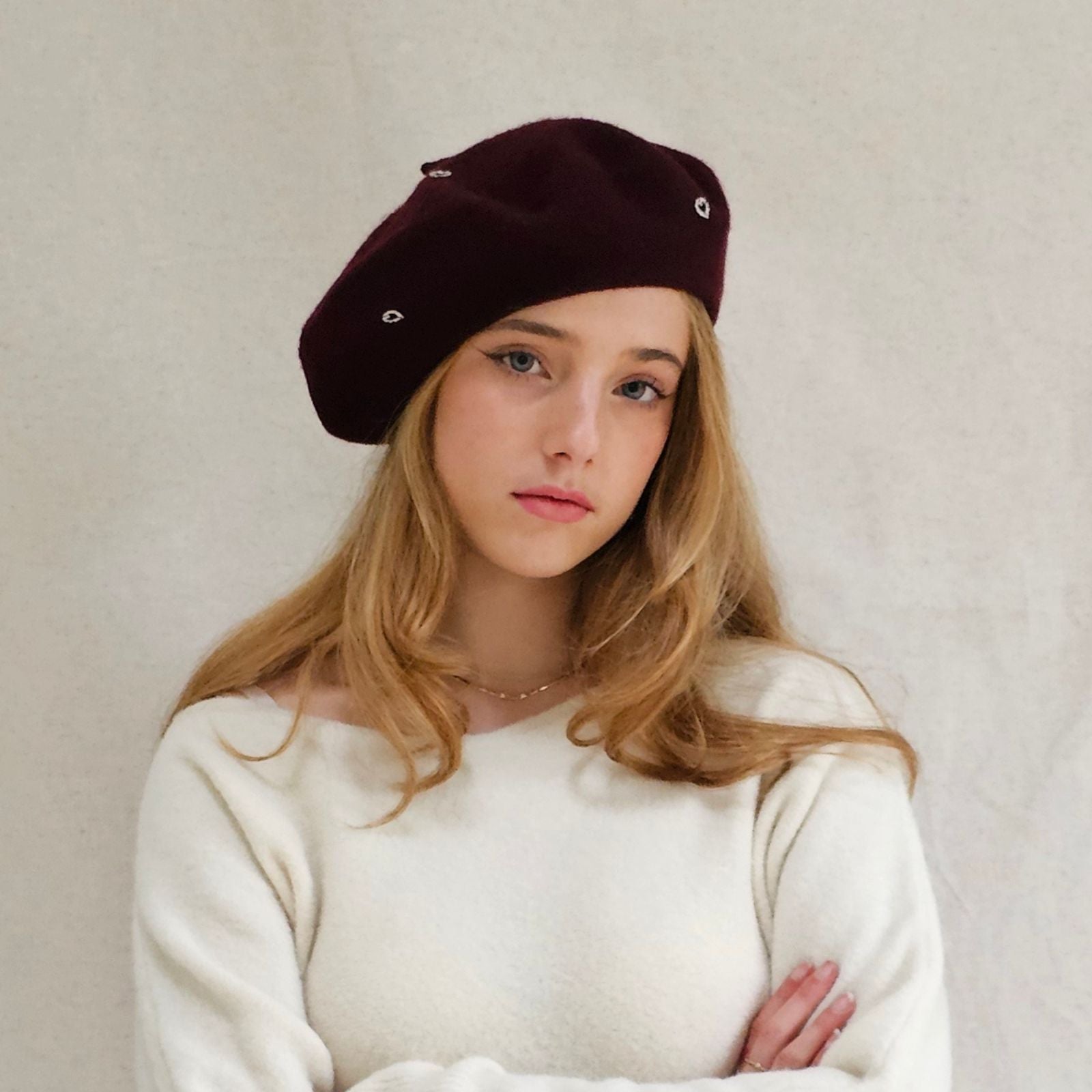 Burgundy wool beret with beautiful silver heart embellishments, front view.