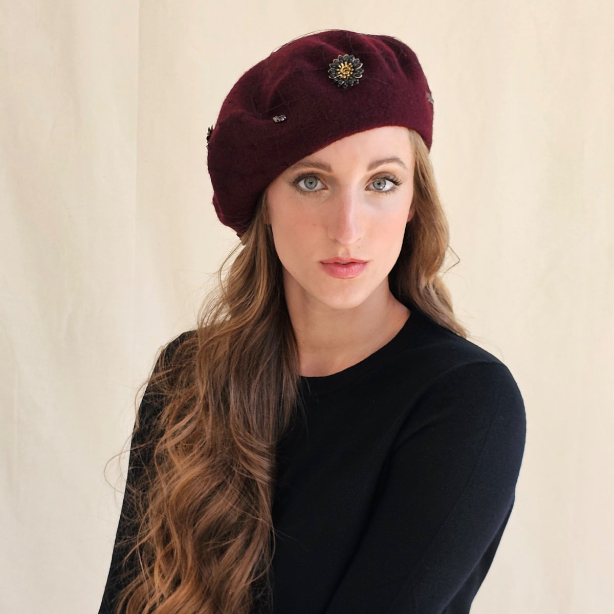 Burgundy wool beret with dark flower embellishment and
monograms.