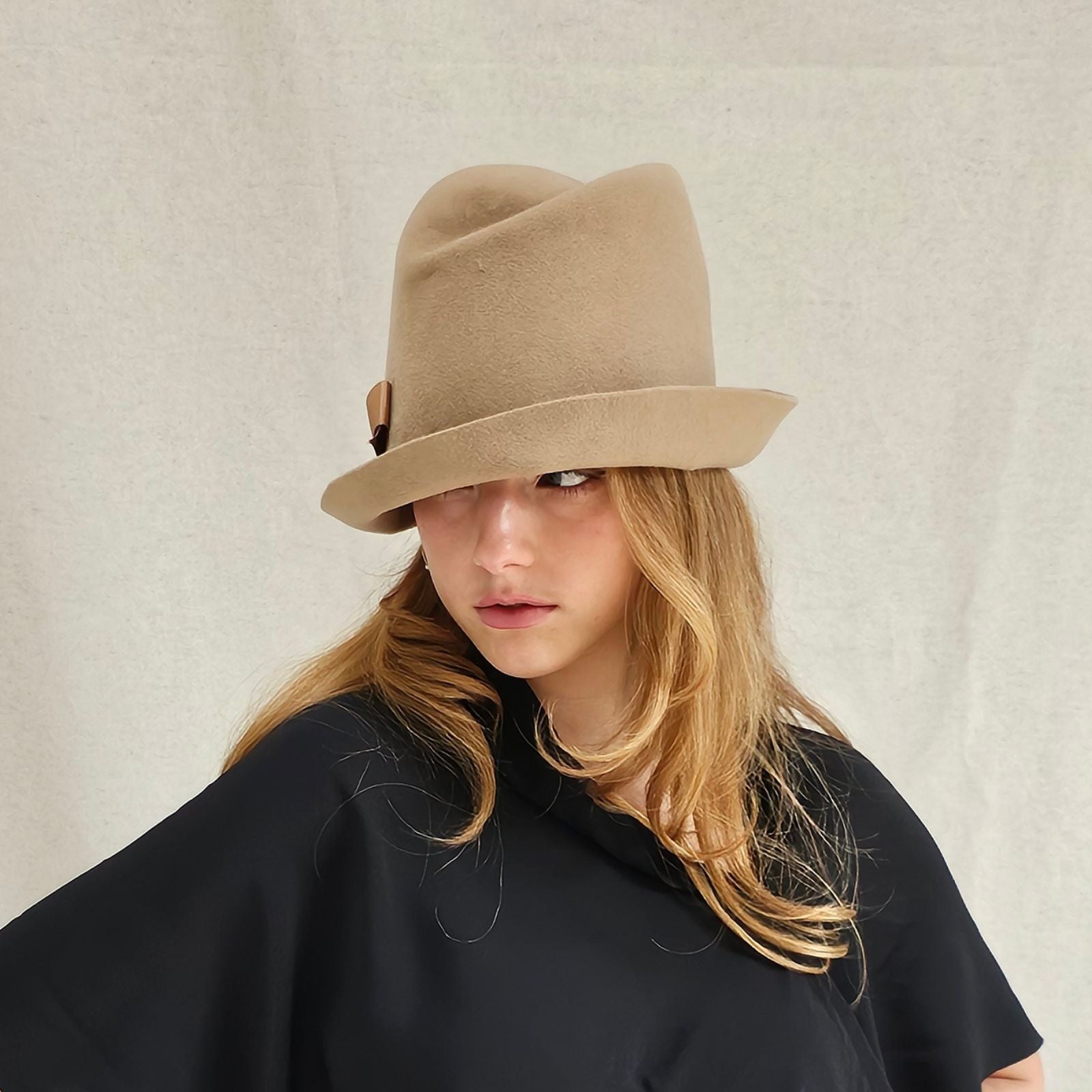 Camel felt trilby with beautiful bow, left view.