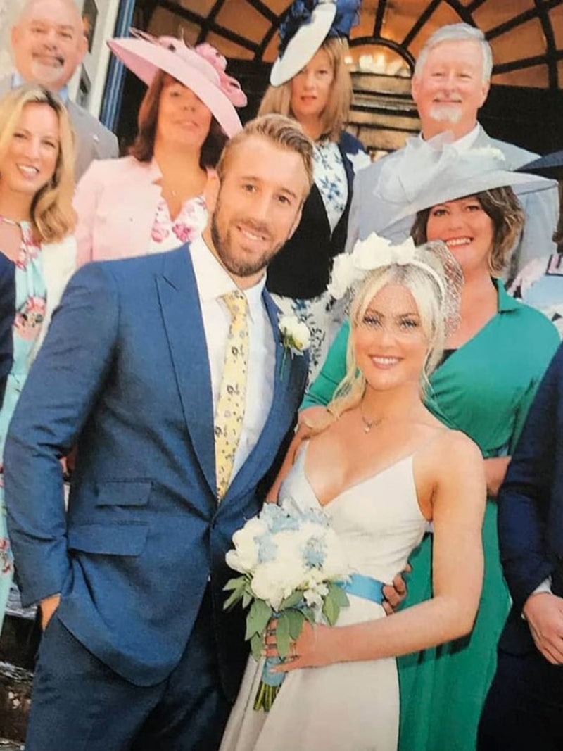 Camila Kerslake wears a white  bridal headband with flowers and birdcage veil by Nerida Fraiman on her wedding to Chris Robshaw.