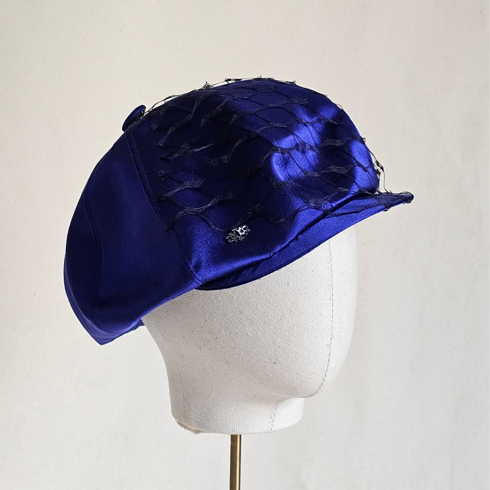 Cobalt silk baker boy hat with black veiling, right view.