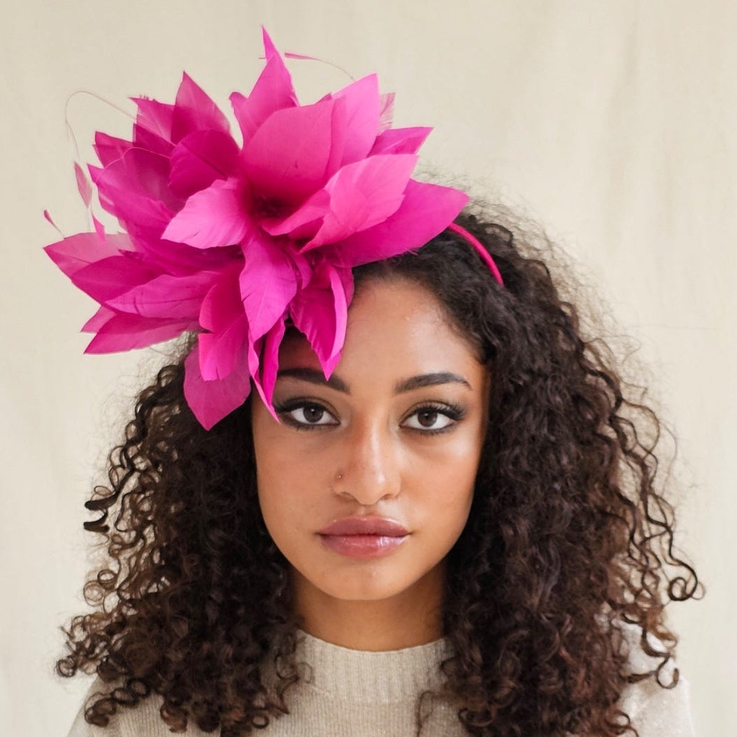 Fuchsia elegant feather fascinator on model.