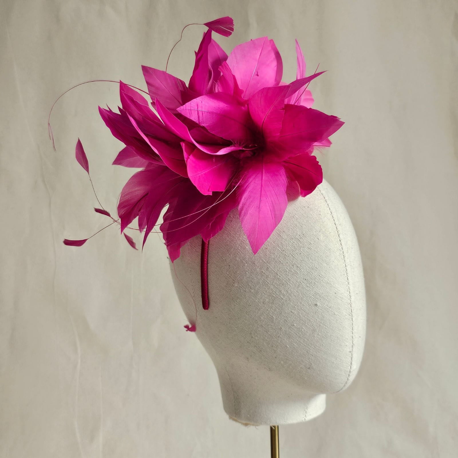 Fuchsia elegant feather flower fascinator, side view.