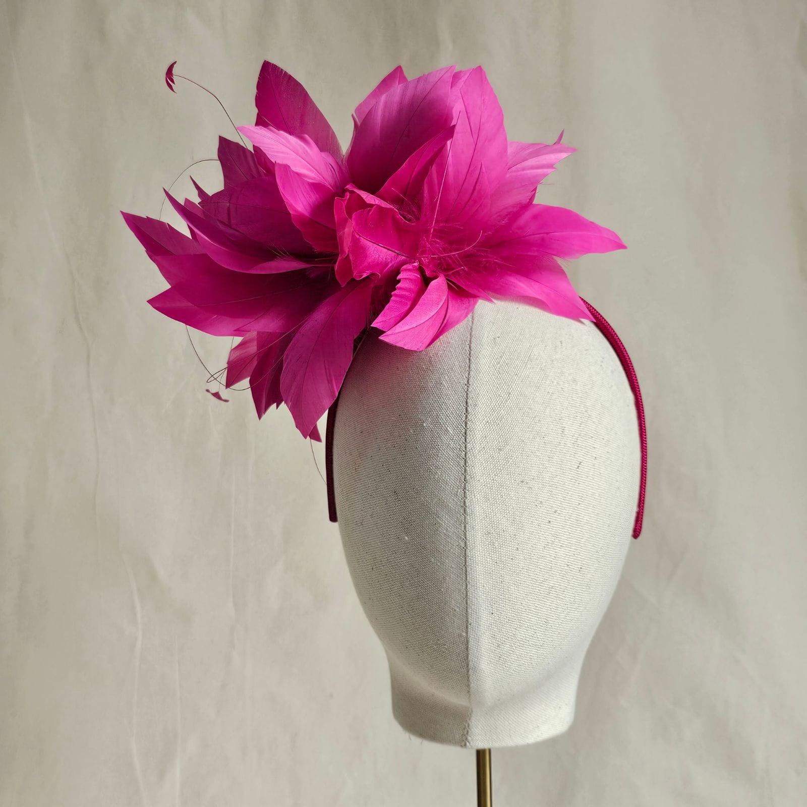 Fuchsia elegant feather flower fascinator, front view.
