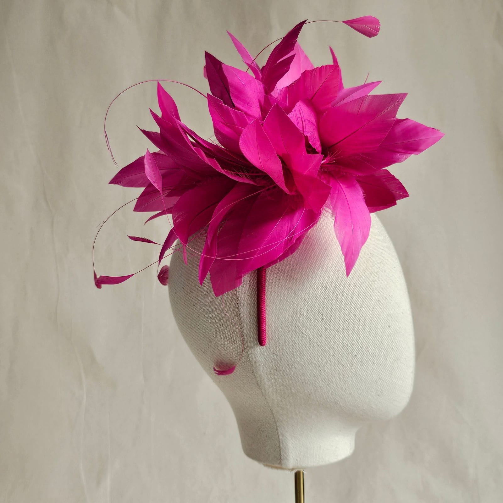 Fuchsia elegant feather flower fascinator, side view.
