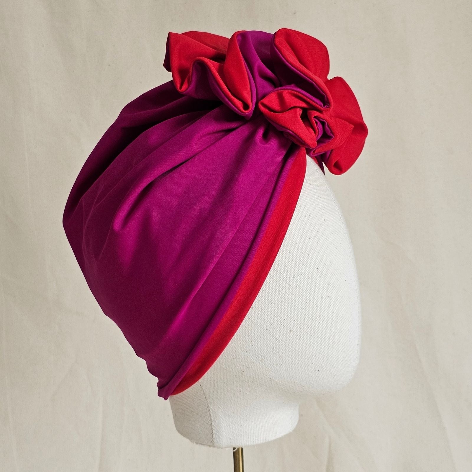 Fuchsia and red swim turban loosely gathered into beautiful ruffle, side view.