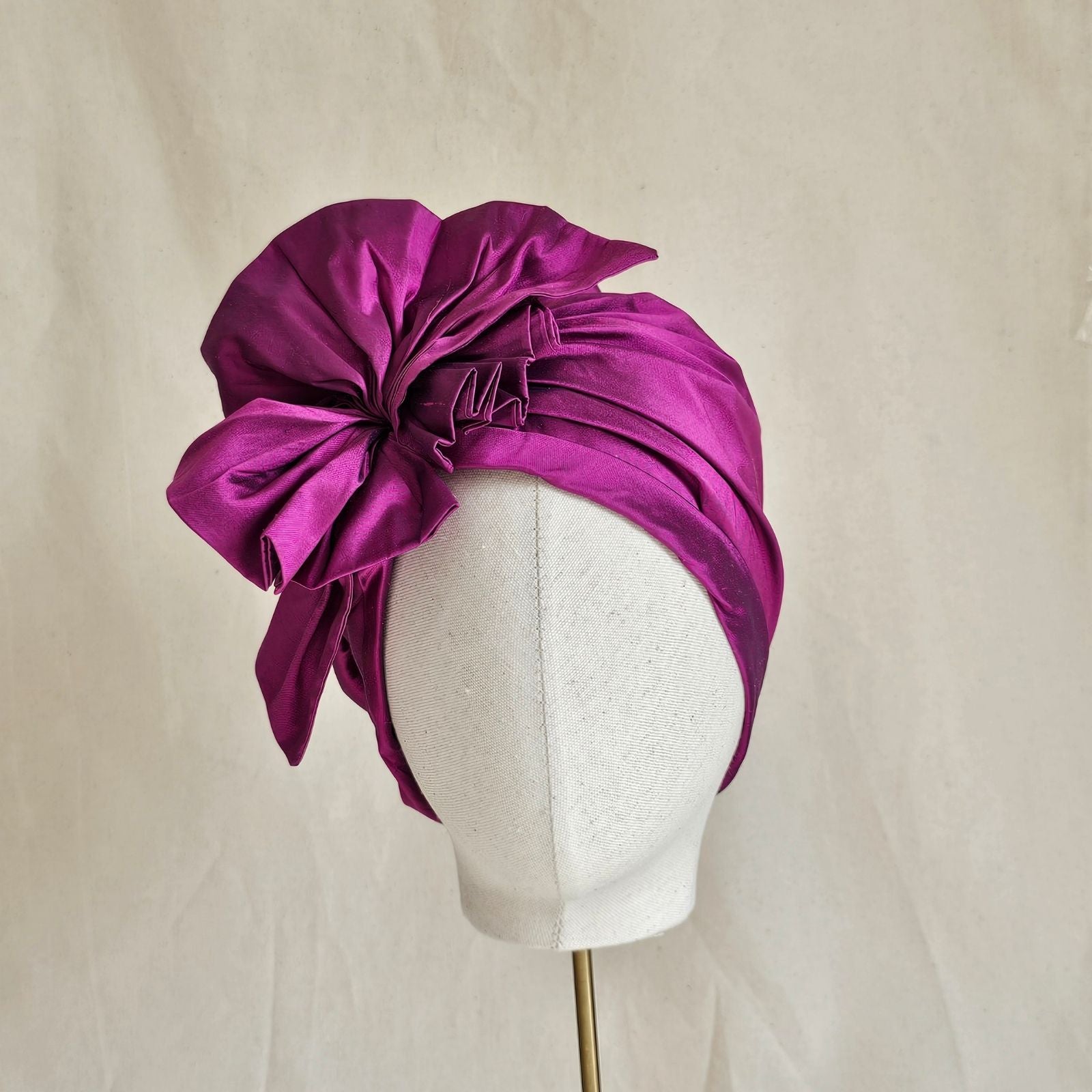 Fuchsia silk turban with intricate ruffle, front view.