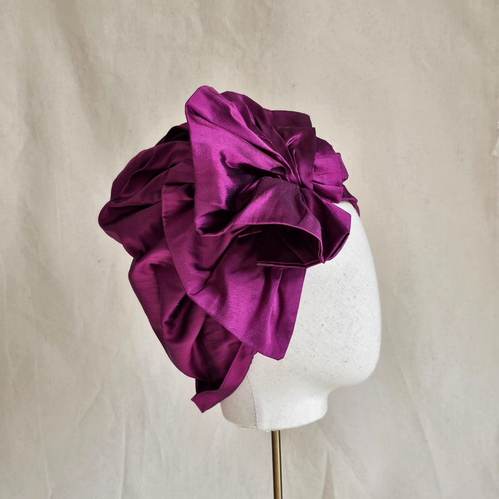 Fuchsia silk turban with intricate ruffle, side view.