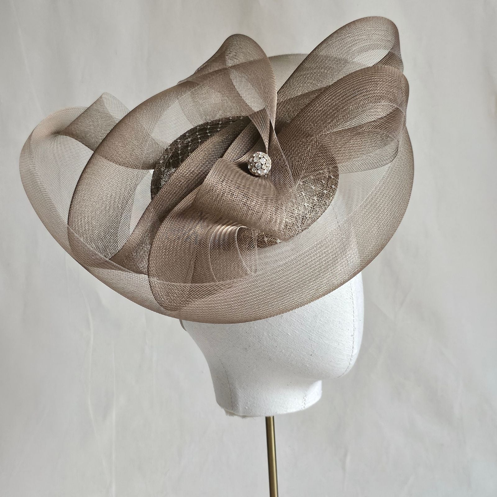 Gold fascinator with elegant crin swirls and crystal diamanté globe embellishment, right view.