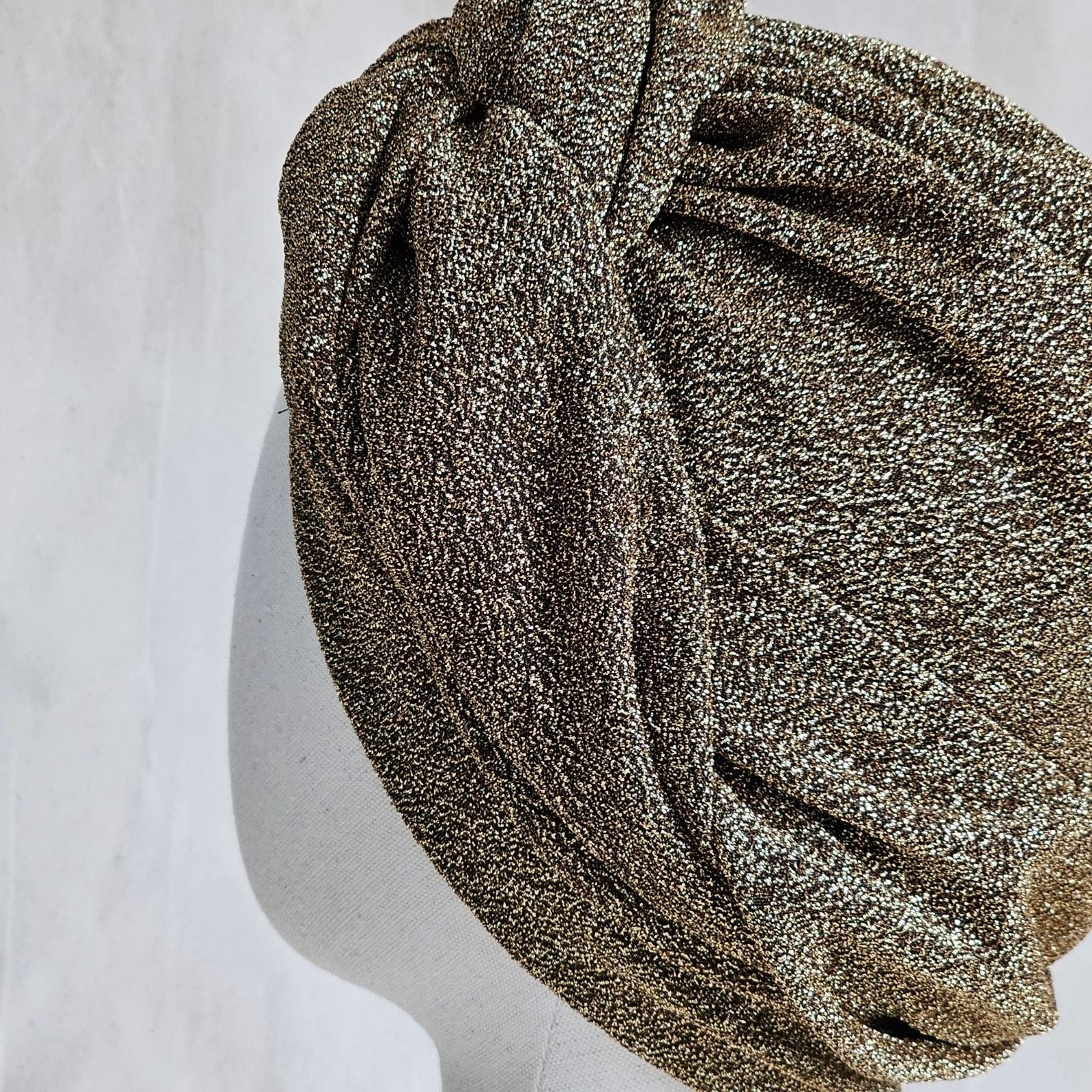Detail of gold lurex intricately tied turban.