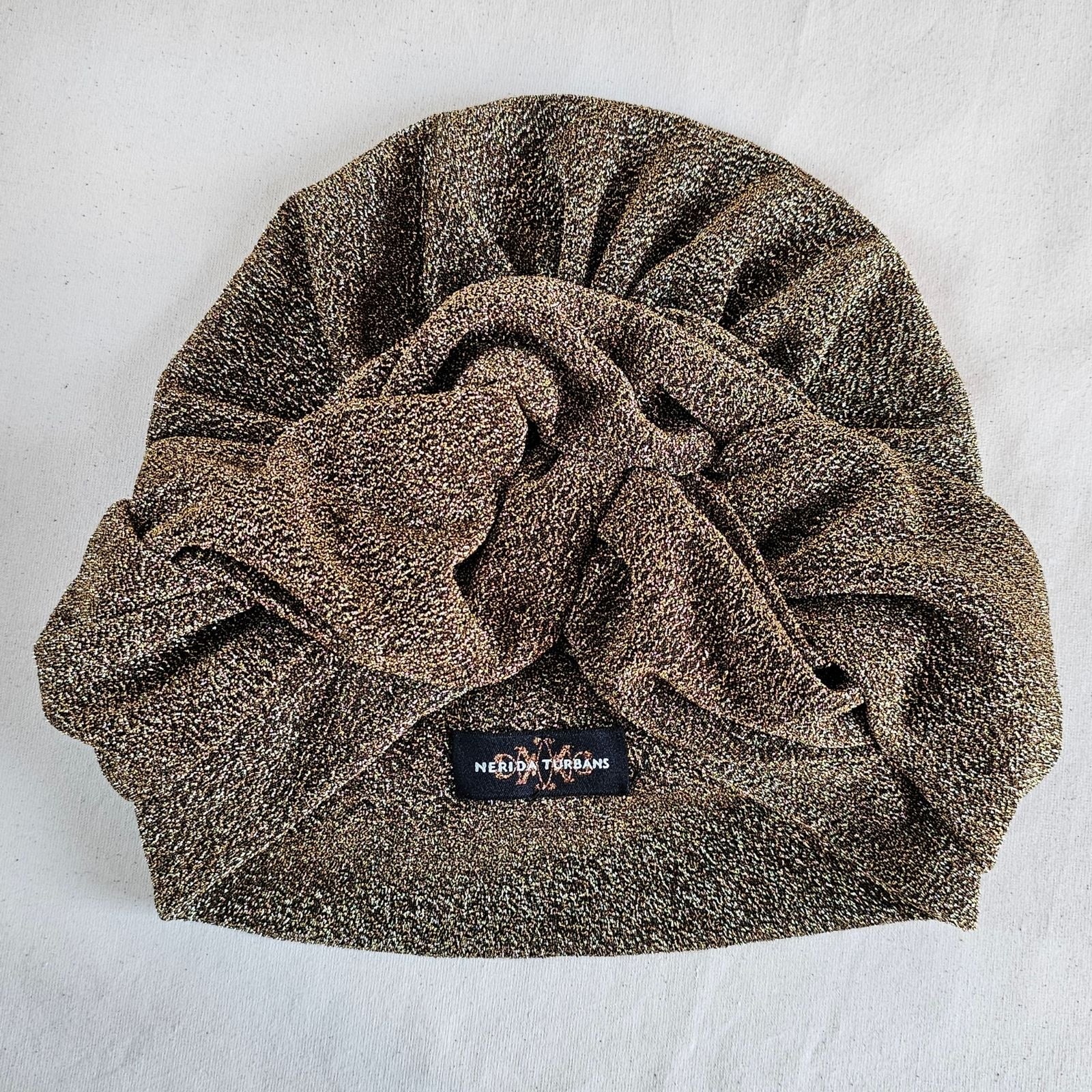 Gold lurex turban with beautifully crafted front knot, top view.