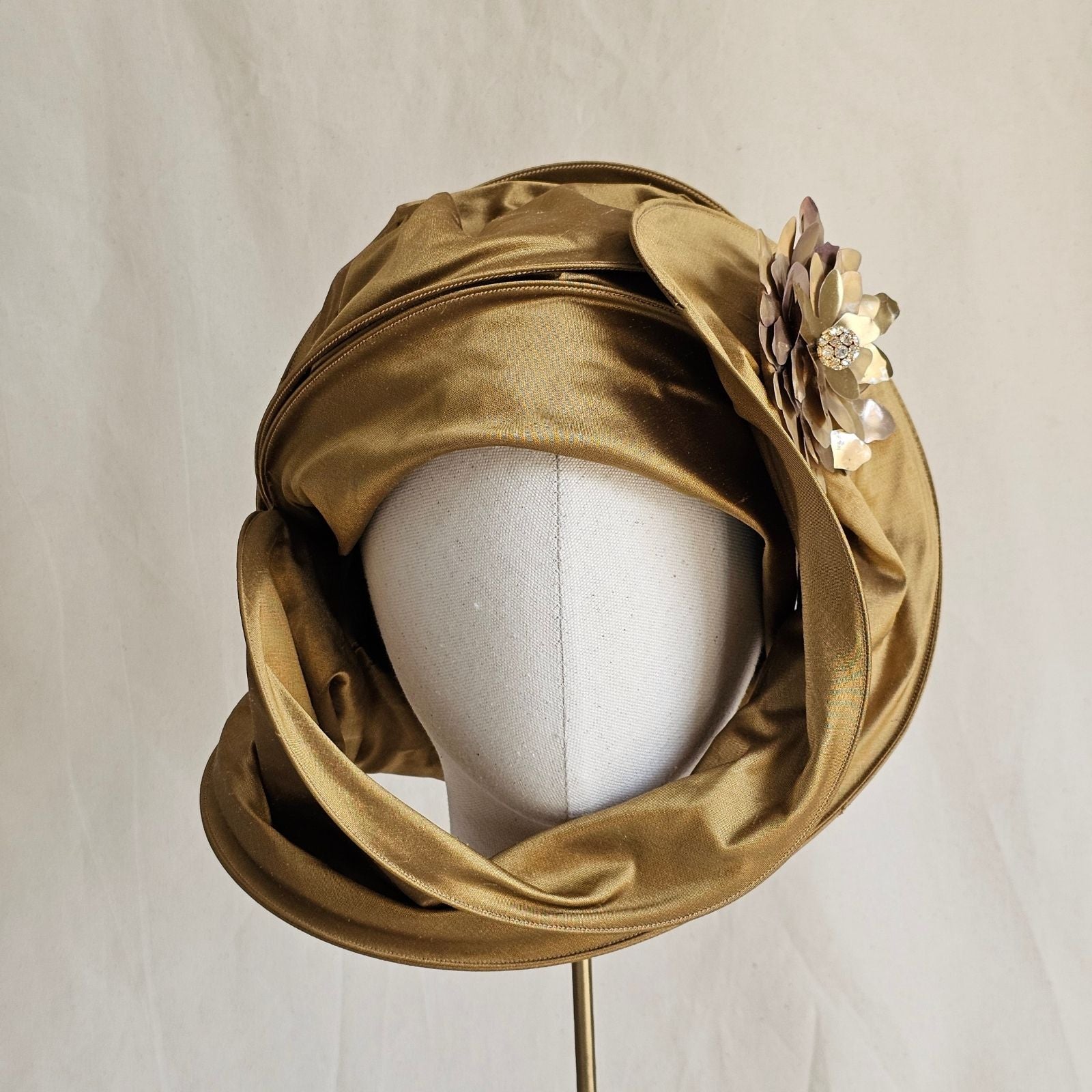 Gold silk scarf turban with beautiful flower brooch, front view.