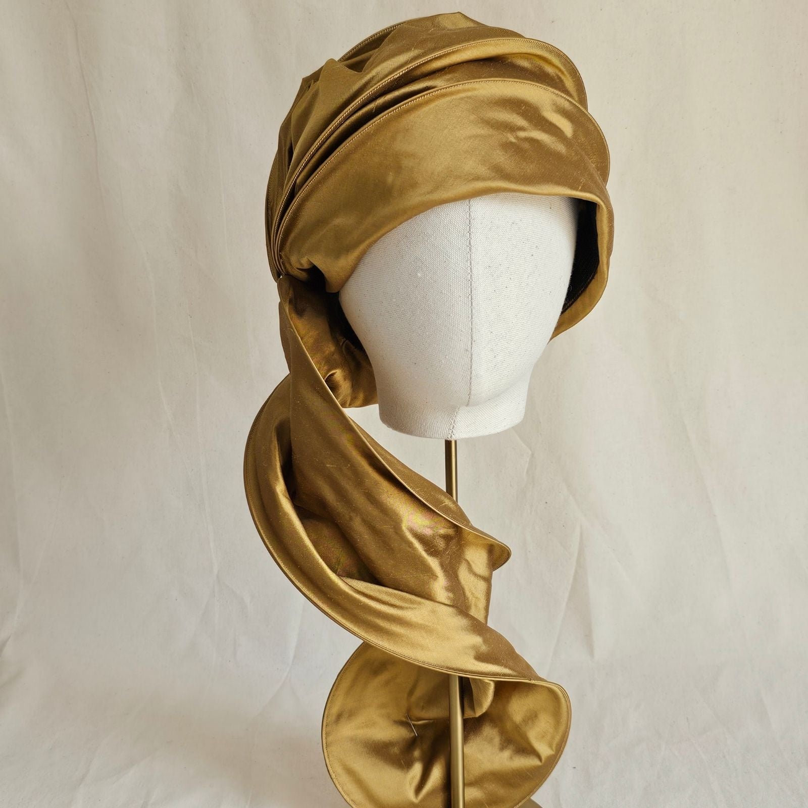 Gold silk scarf turban loosely draped, front view.