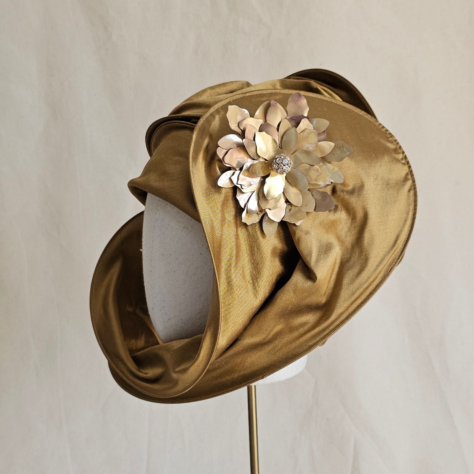 Gold silk scarf turban with beautiful diamanté globe flower brooch, side view.
