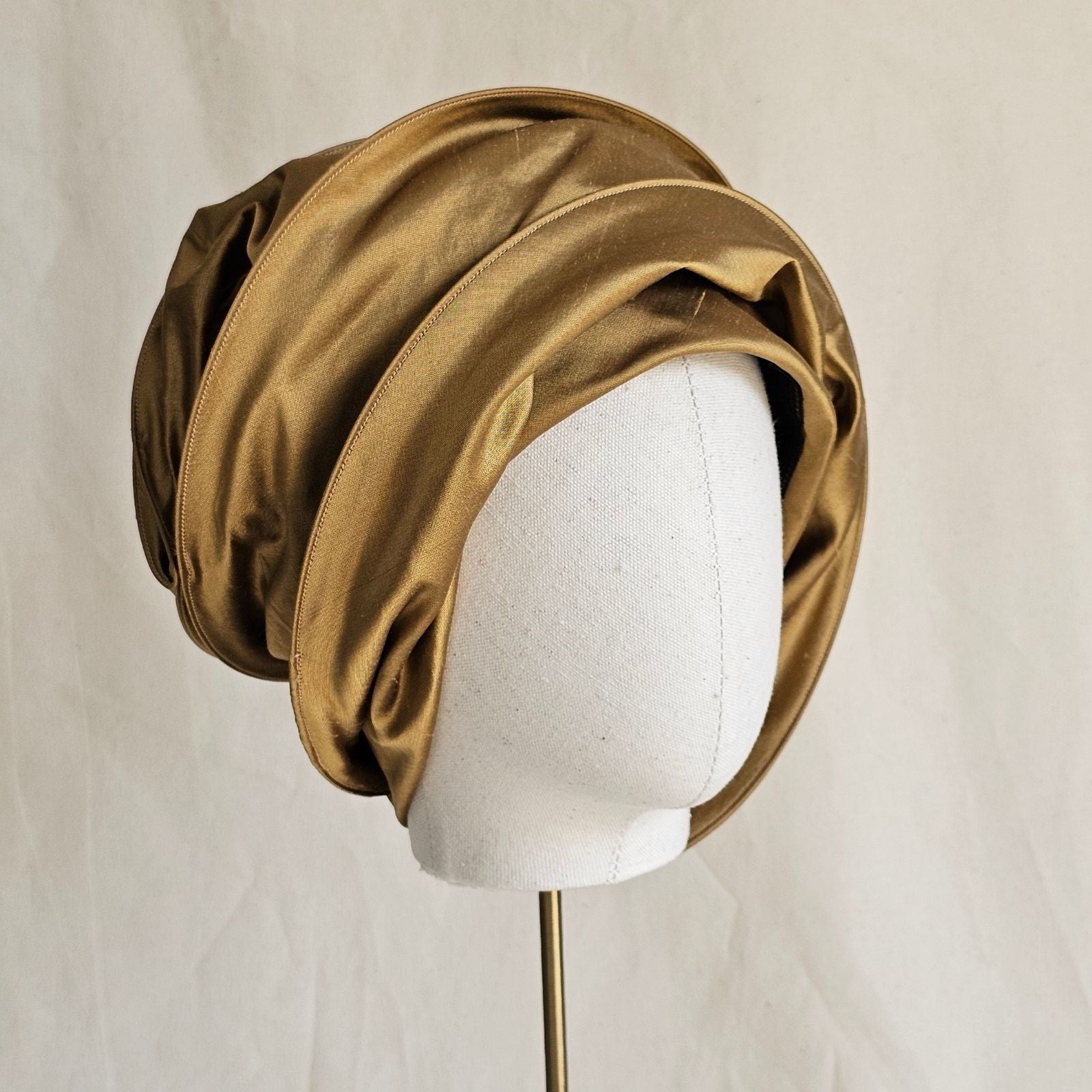 Gold silk scarf turban, tied left view.