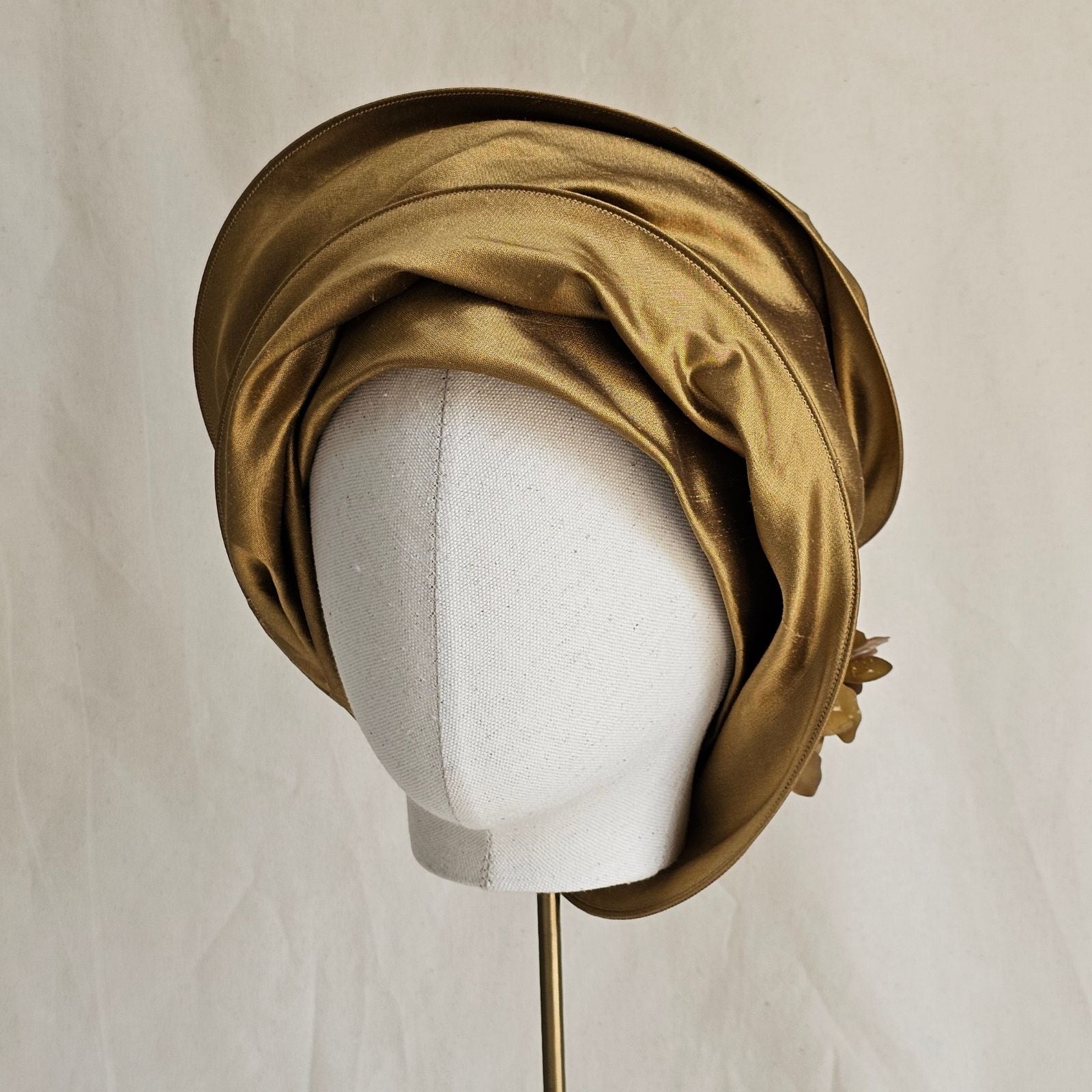 Gold silk scarf tied turban, front view.