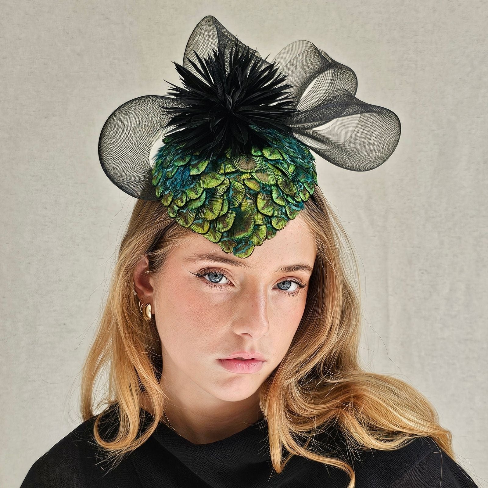 Green peacock feather hat with black feather flower and elegant crin swirl, front view.