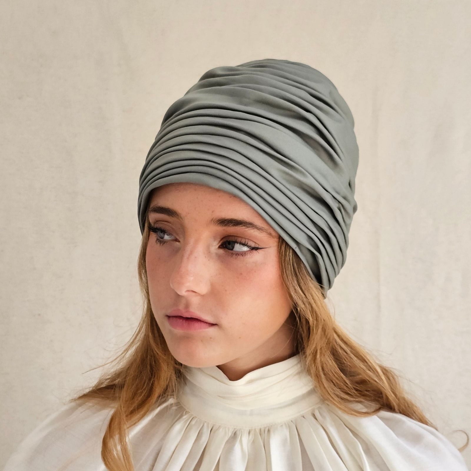 Green cotton gathered turban, left view.