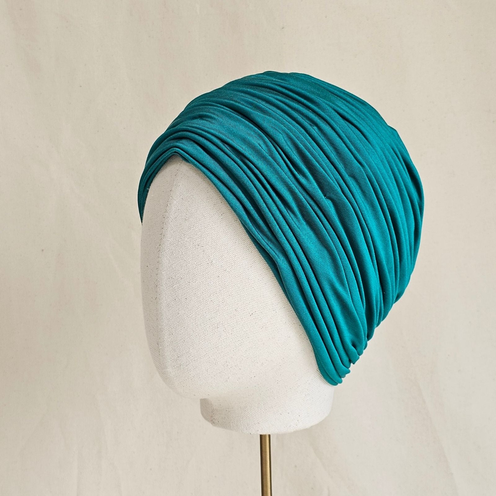 Green silk jersey turban with beautiful gathers, side view.