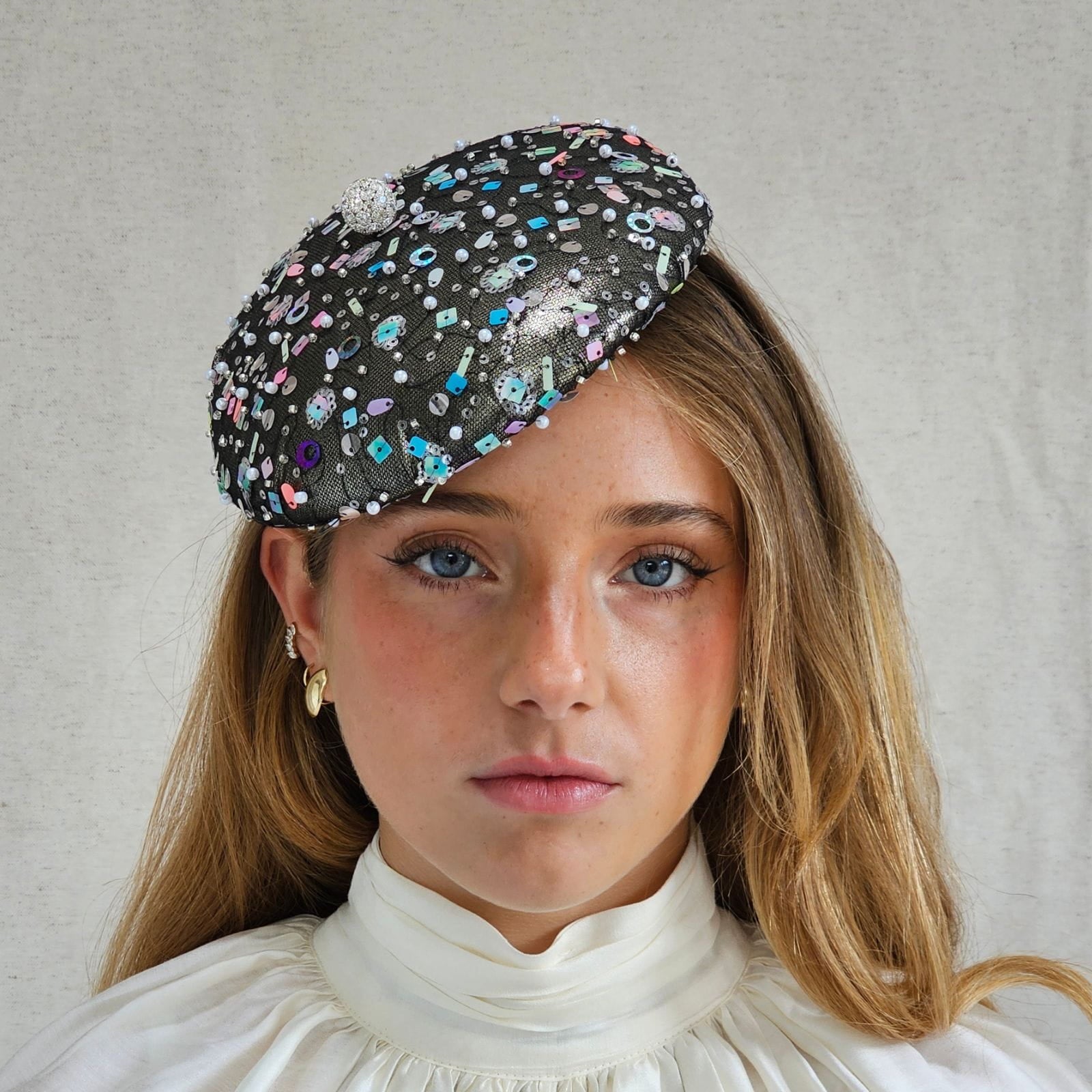 Gunmetal lamé beret with multicolour tulle sequining and crystal diamanté globe embellishment, front view.