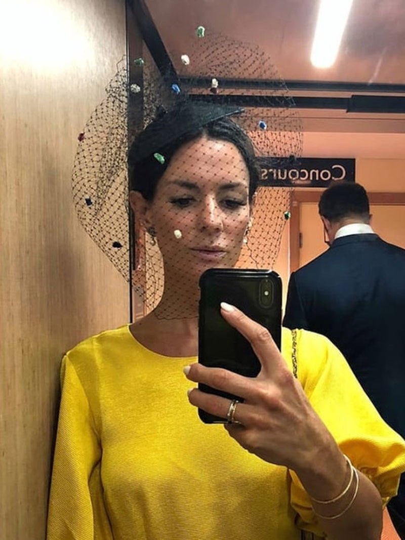 Hedvig Sagfjord Opshau wearing black Nerida Fraiman Ascot fascinator with multicoloured dot veil at Royal Ascot, photographed in mirror selfie.