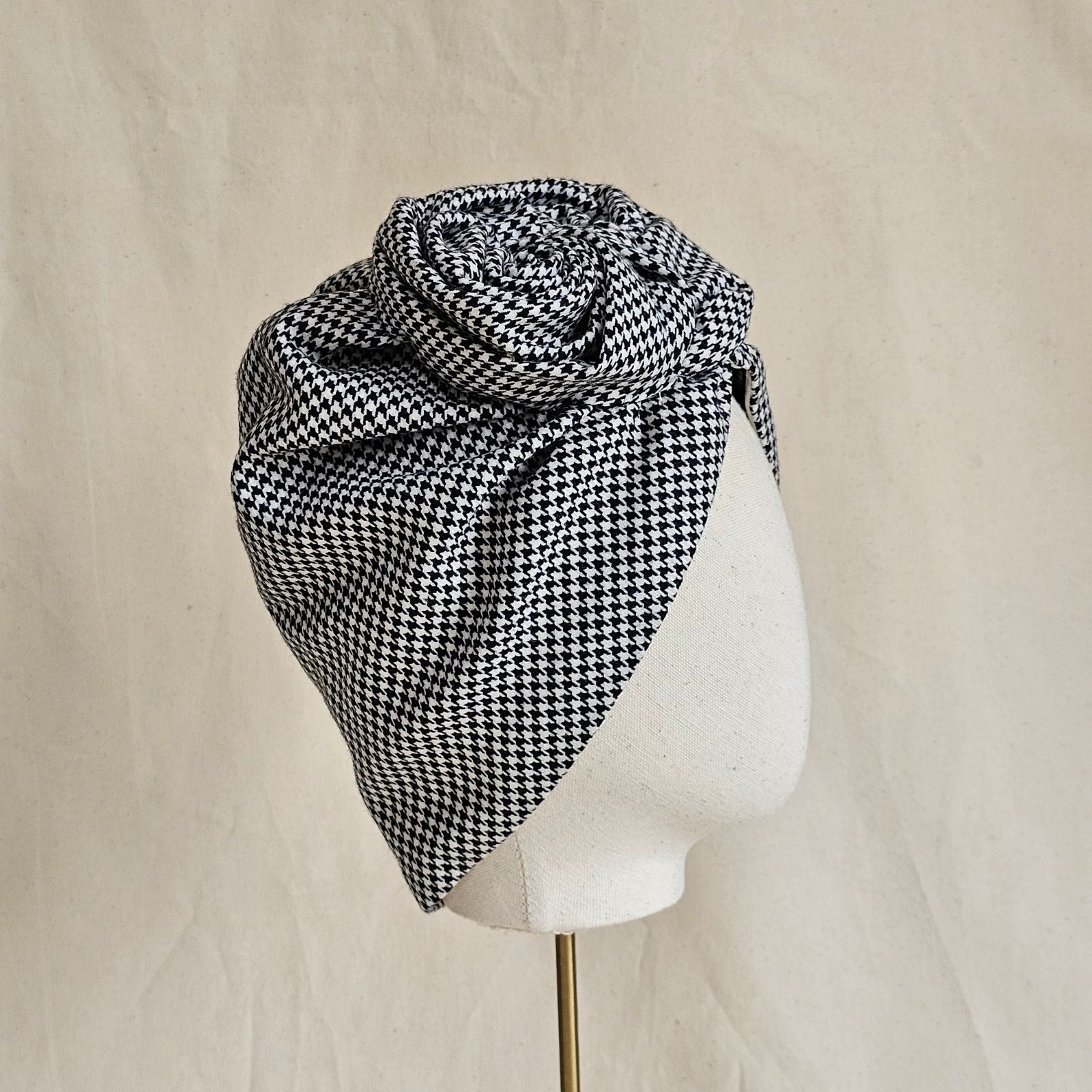 Houndstooth turban with sculpted rose knot, side view.