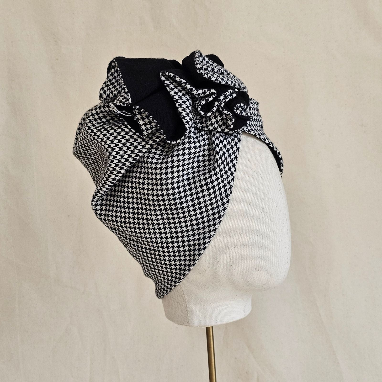Houndstooth turban with intricate ruffle, side view.