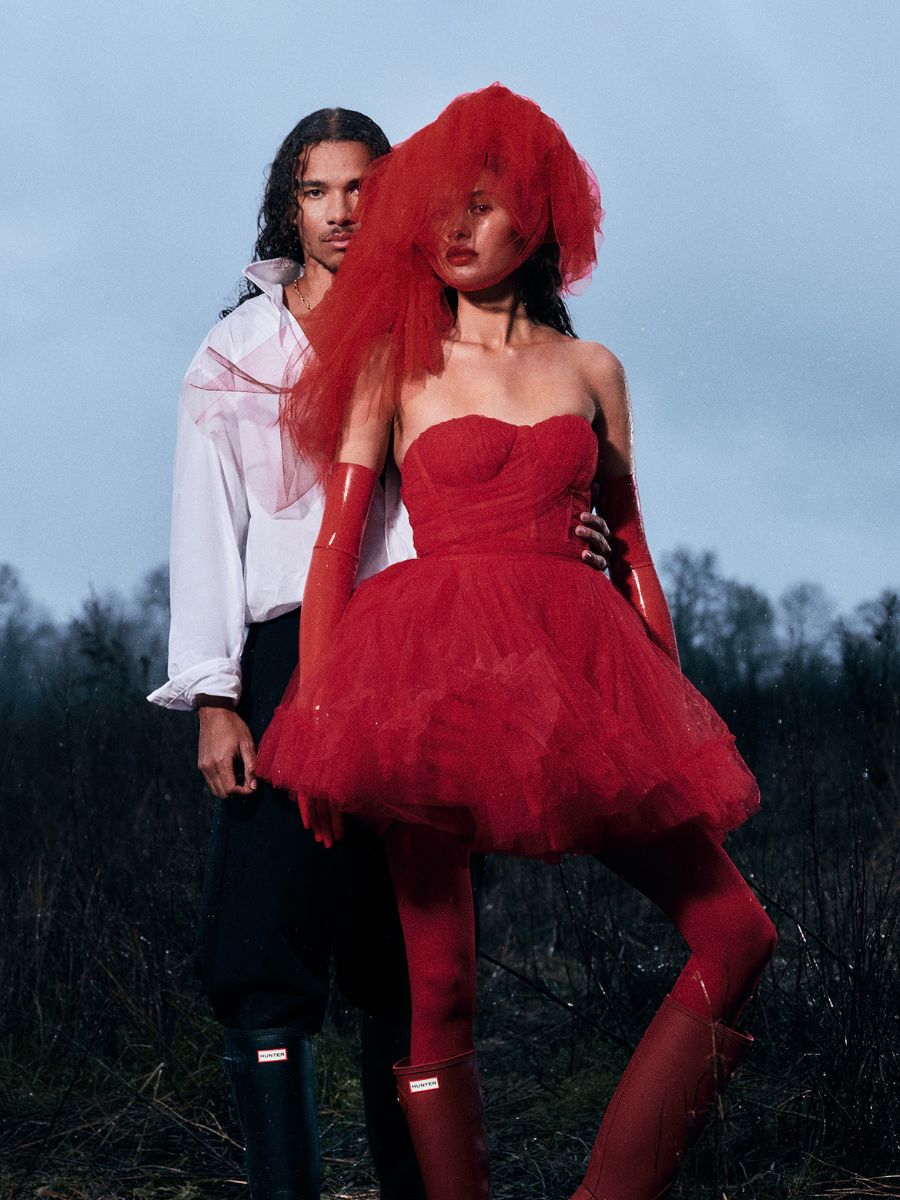Model wearing red tulle hat by Nerida Fraiman for Hunter Boots x Wuthering Heights.