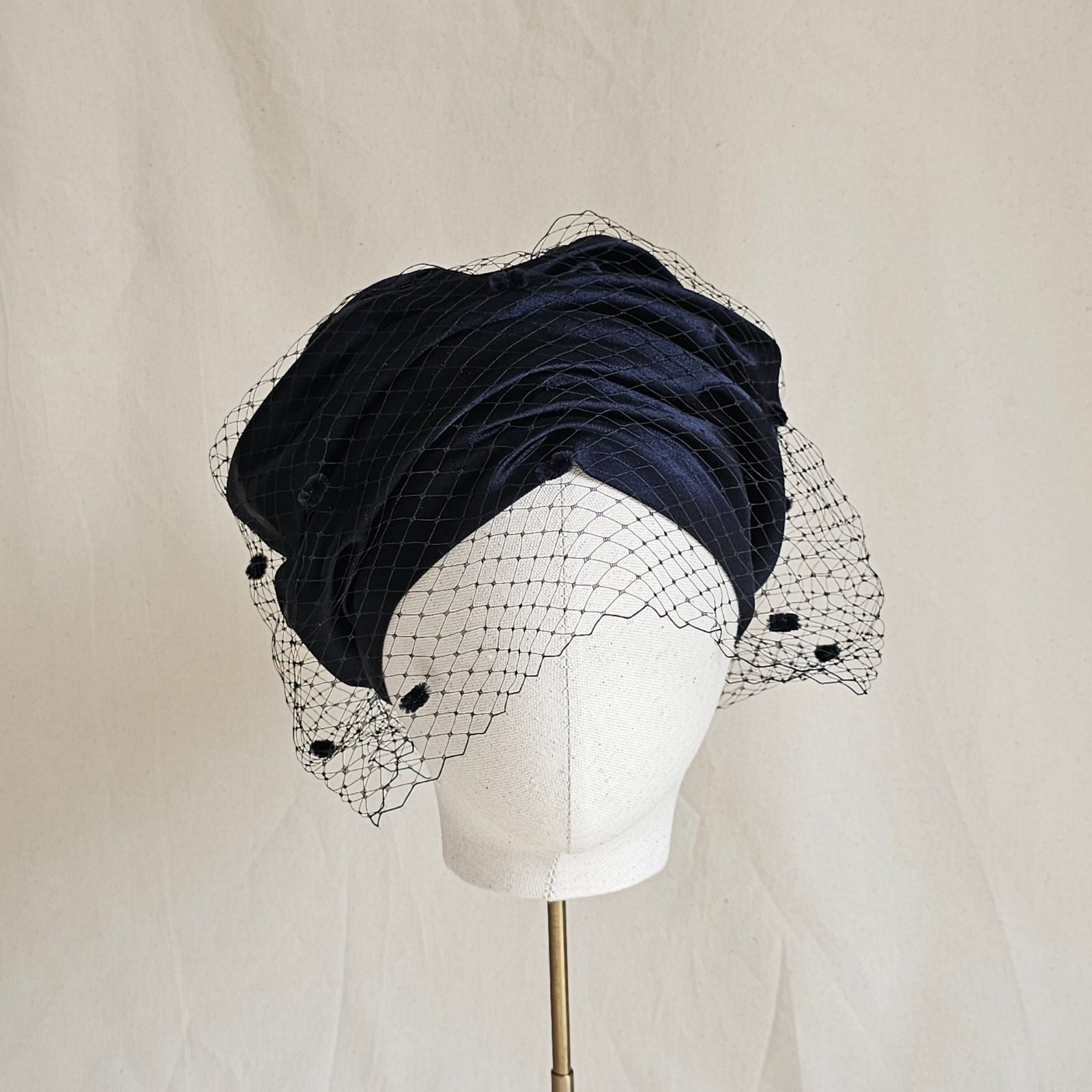 Ink silk and satin beret turban with dotted veil, front view.