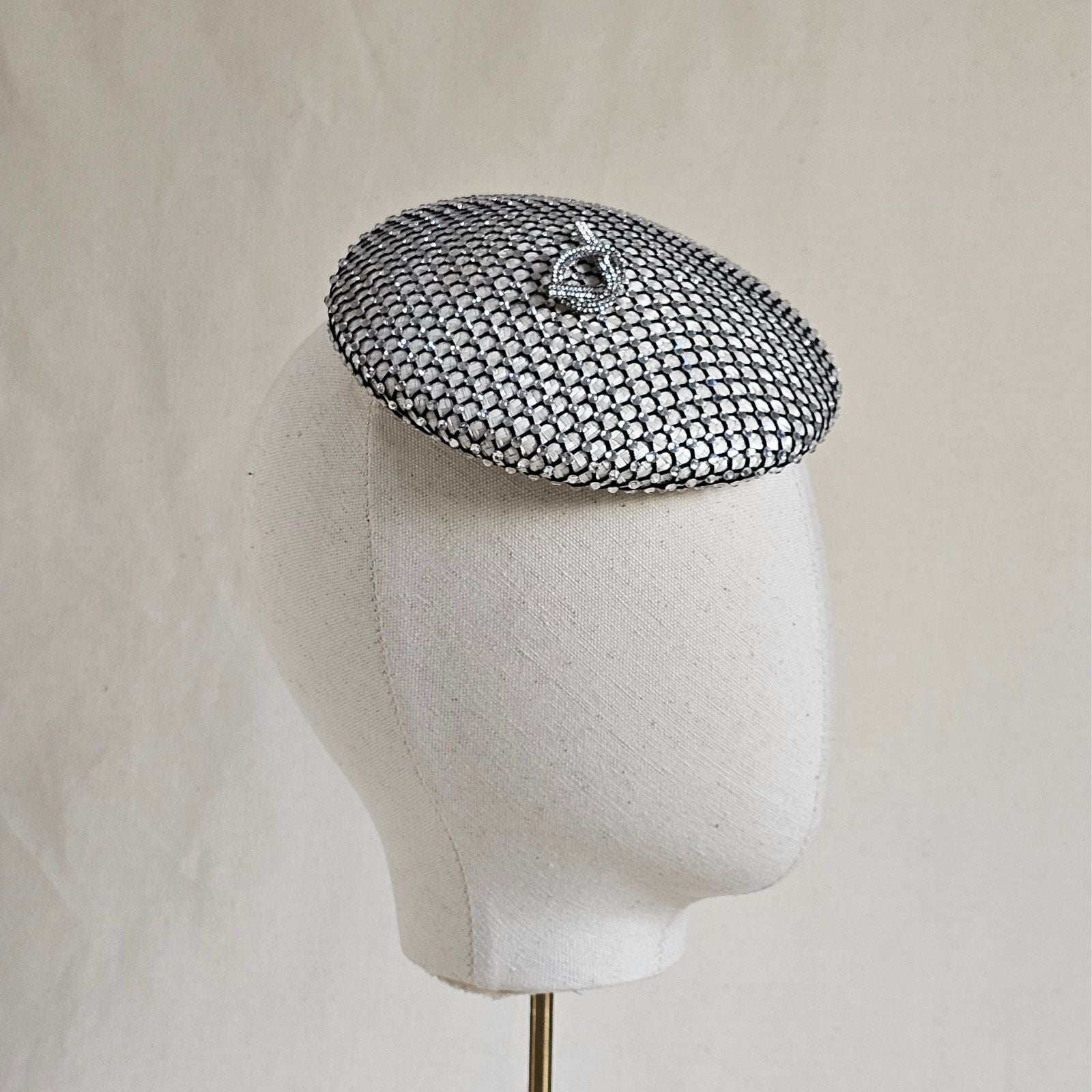 Ivory beret with intricate crysal mesh and beautiful pretzel knot embellishment, side view.
