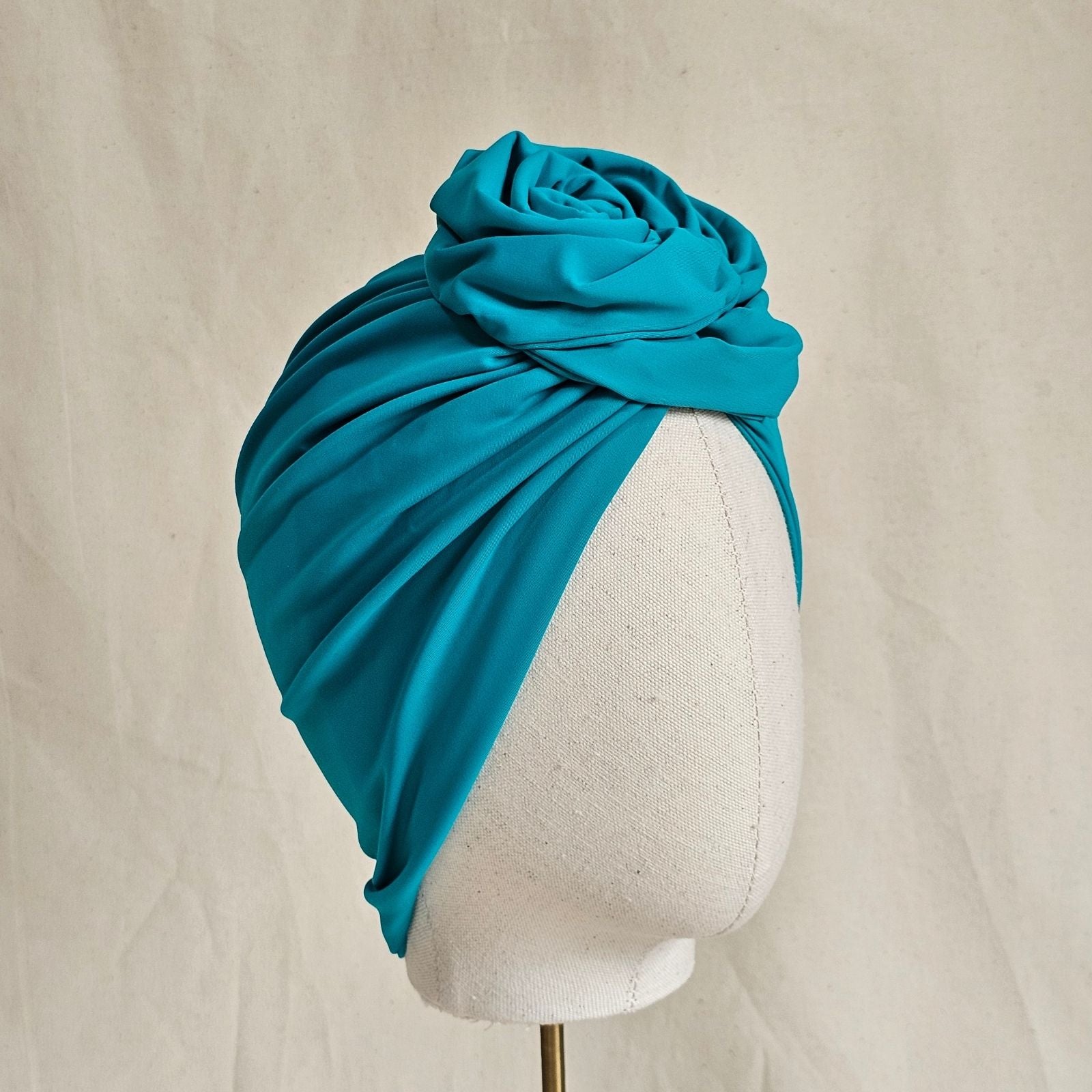 Jade swim turban with beautiful sculpted rose knot, side view.