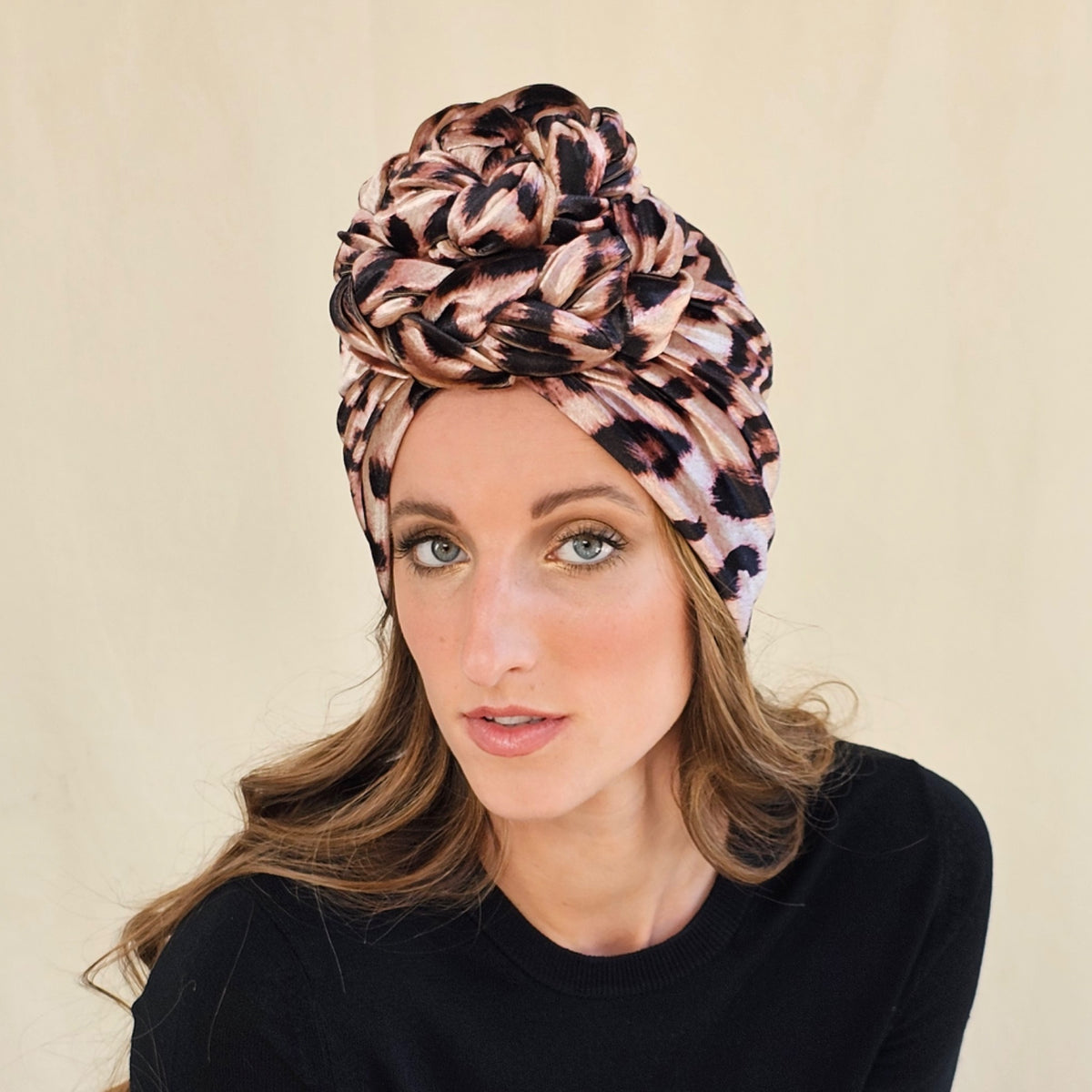 Close-up of leopard print velour turban showing sculptural braid
rose.