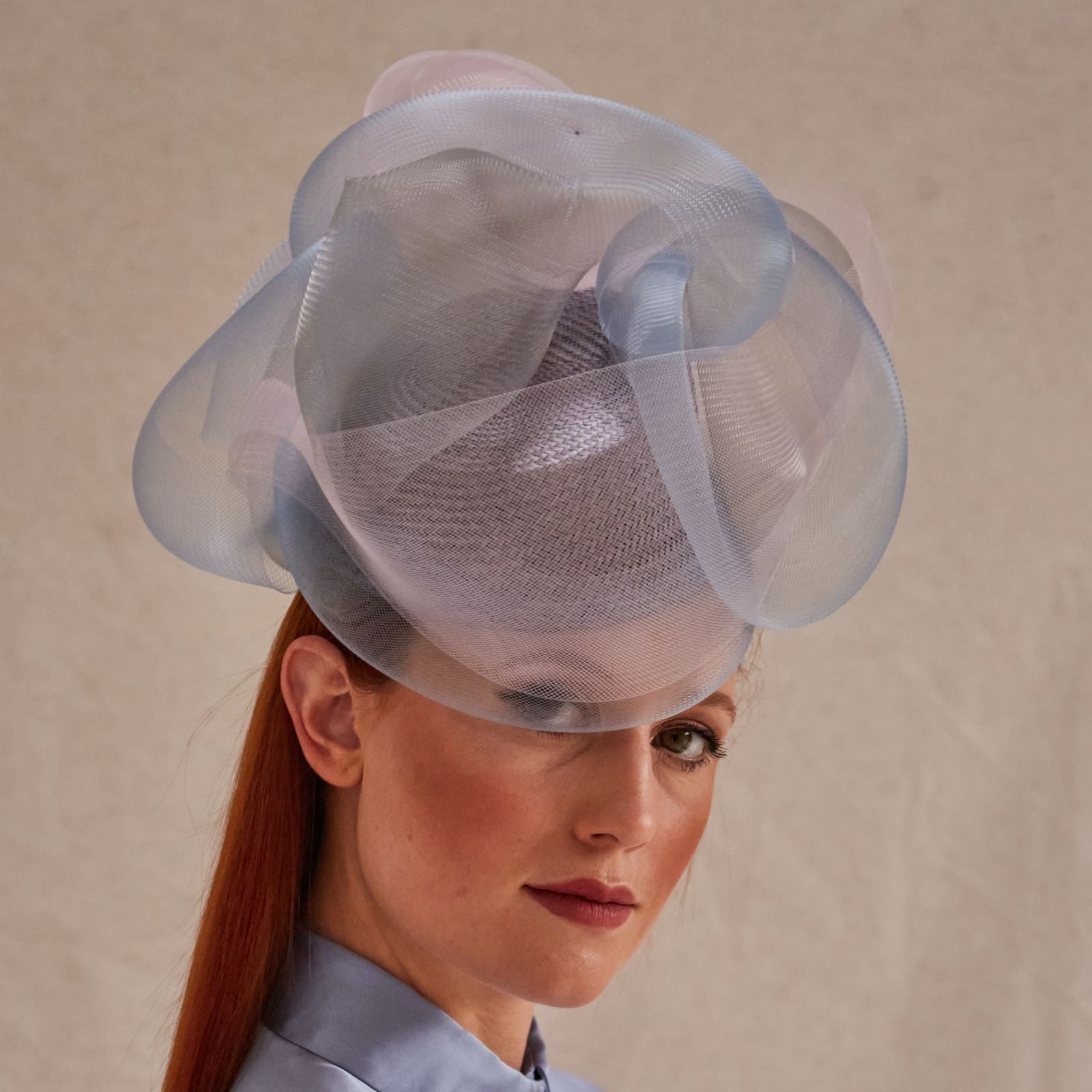 Lilac, blue and pink crin swirl pillbox hat, front view.