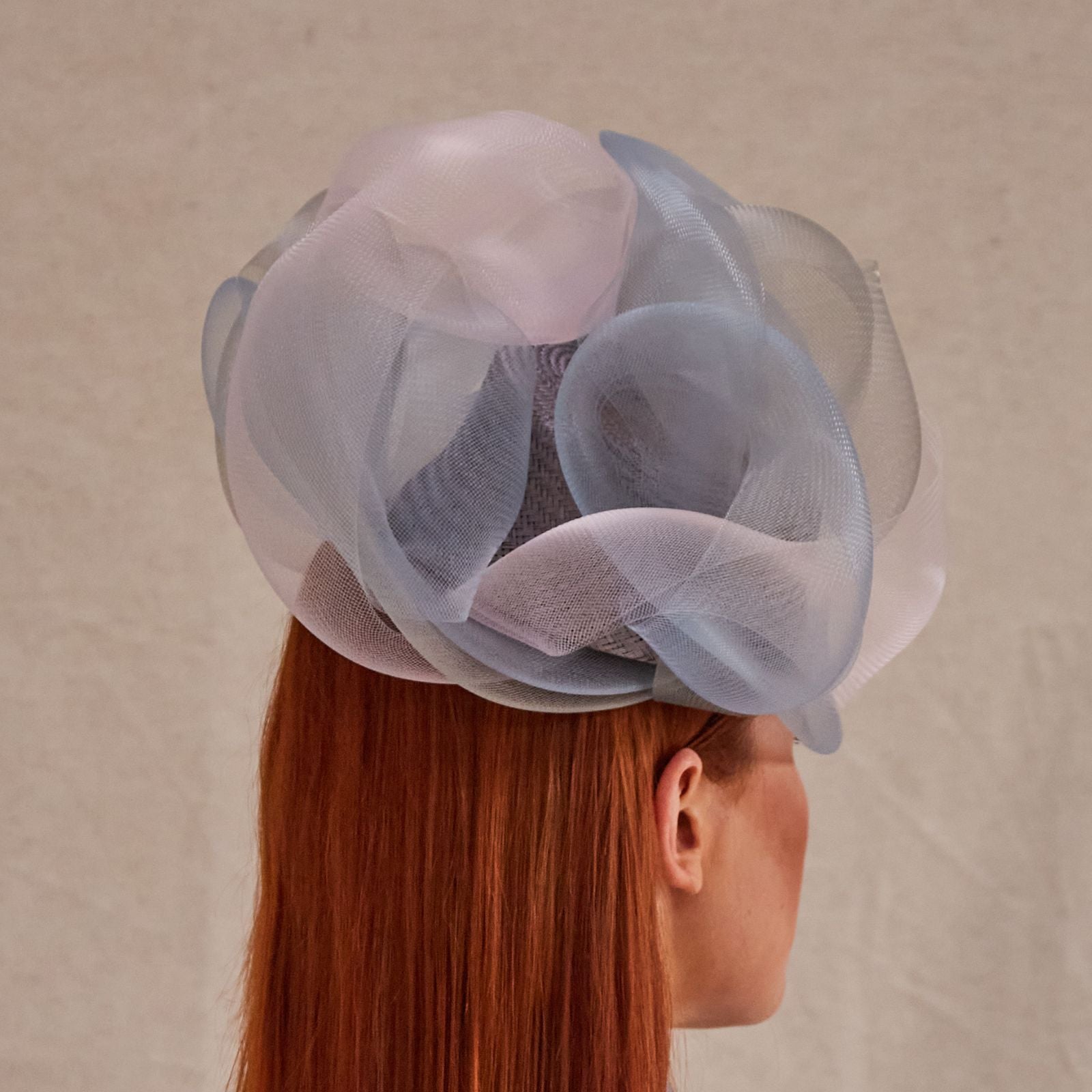 Lilac, blue and pink crin swirl pillbox hat, rear view.