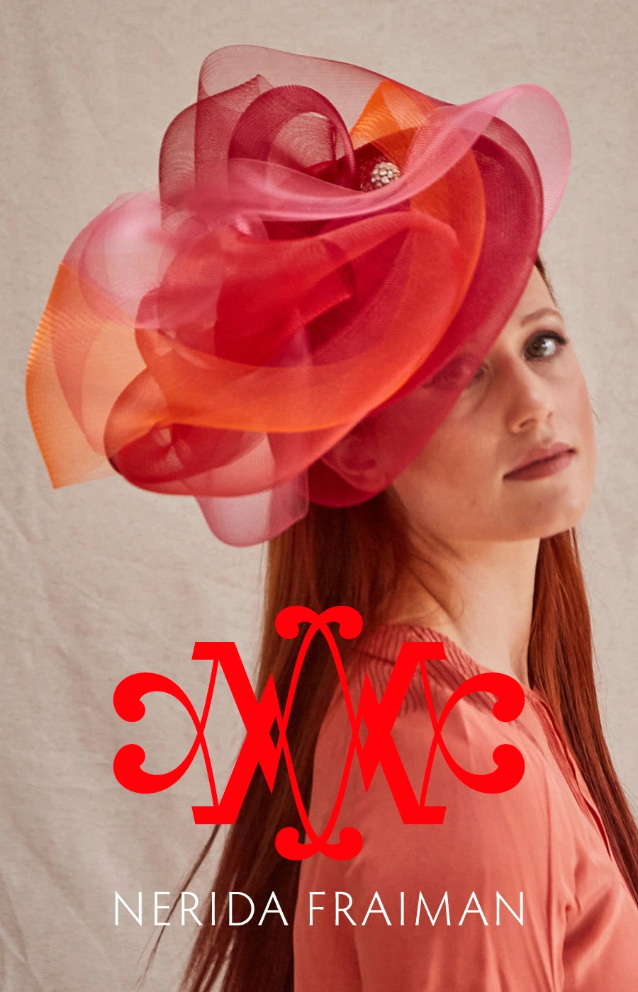 Woman wearing a large pink and red flower hat with 'Nerida Fraiman' branding.