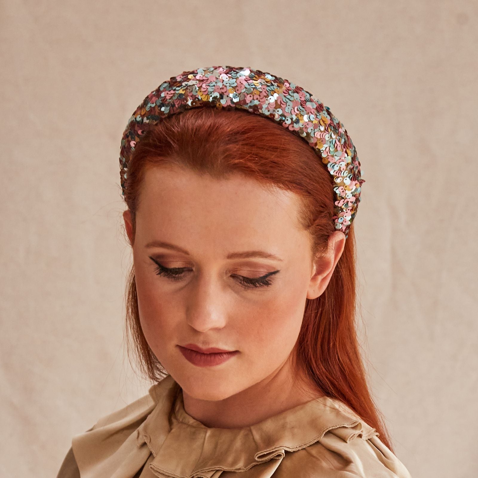 Multicolour pink sequin headband, angle view.